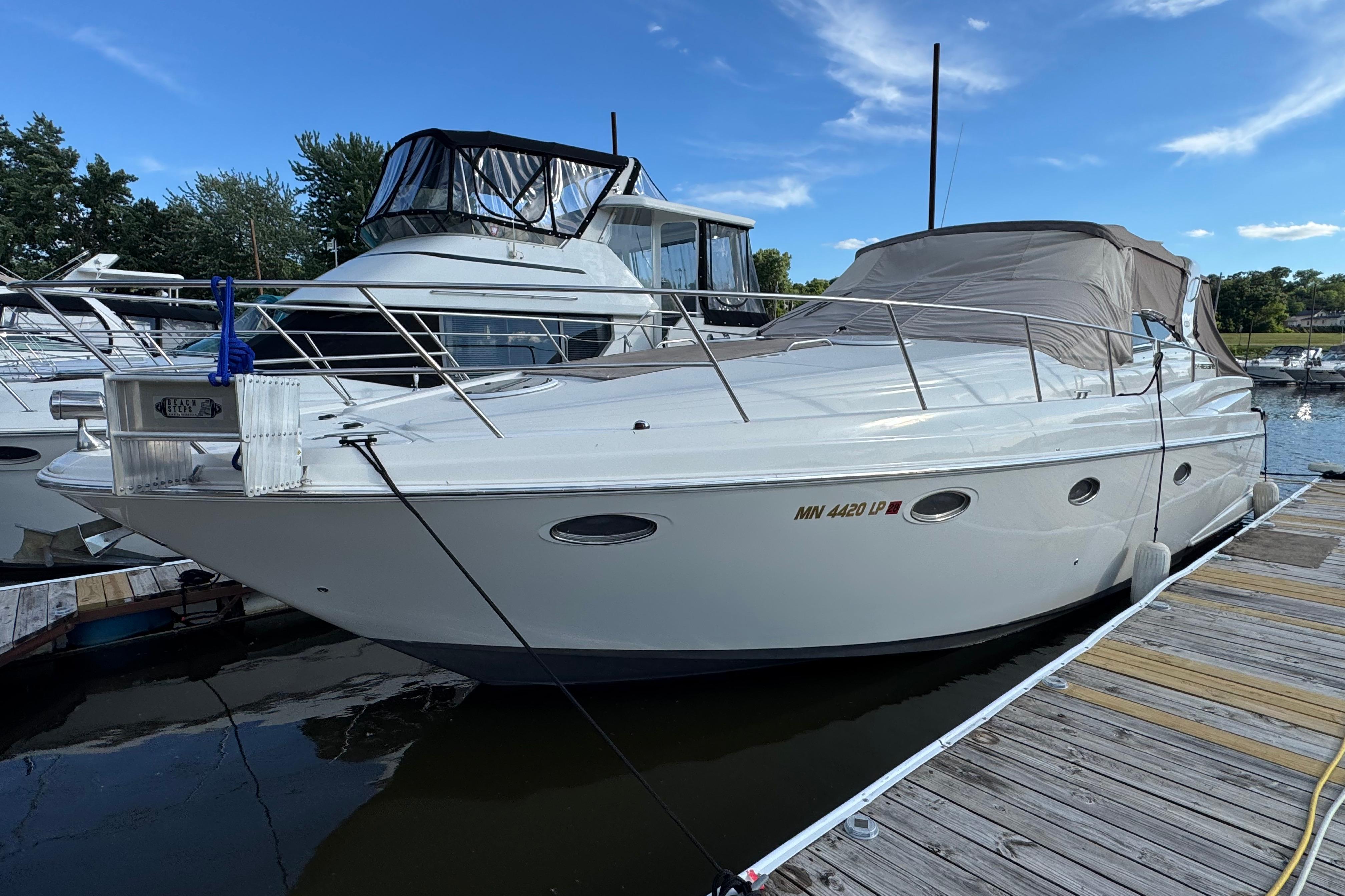 2007 Regal Commodore 3860 yacht docked at marina under clear blue sky.