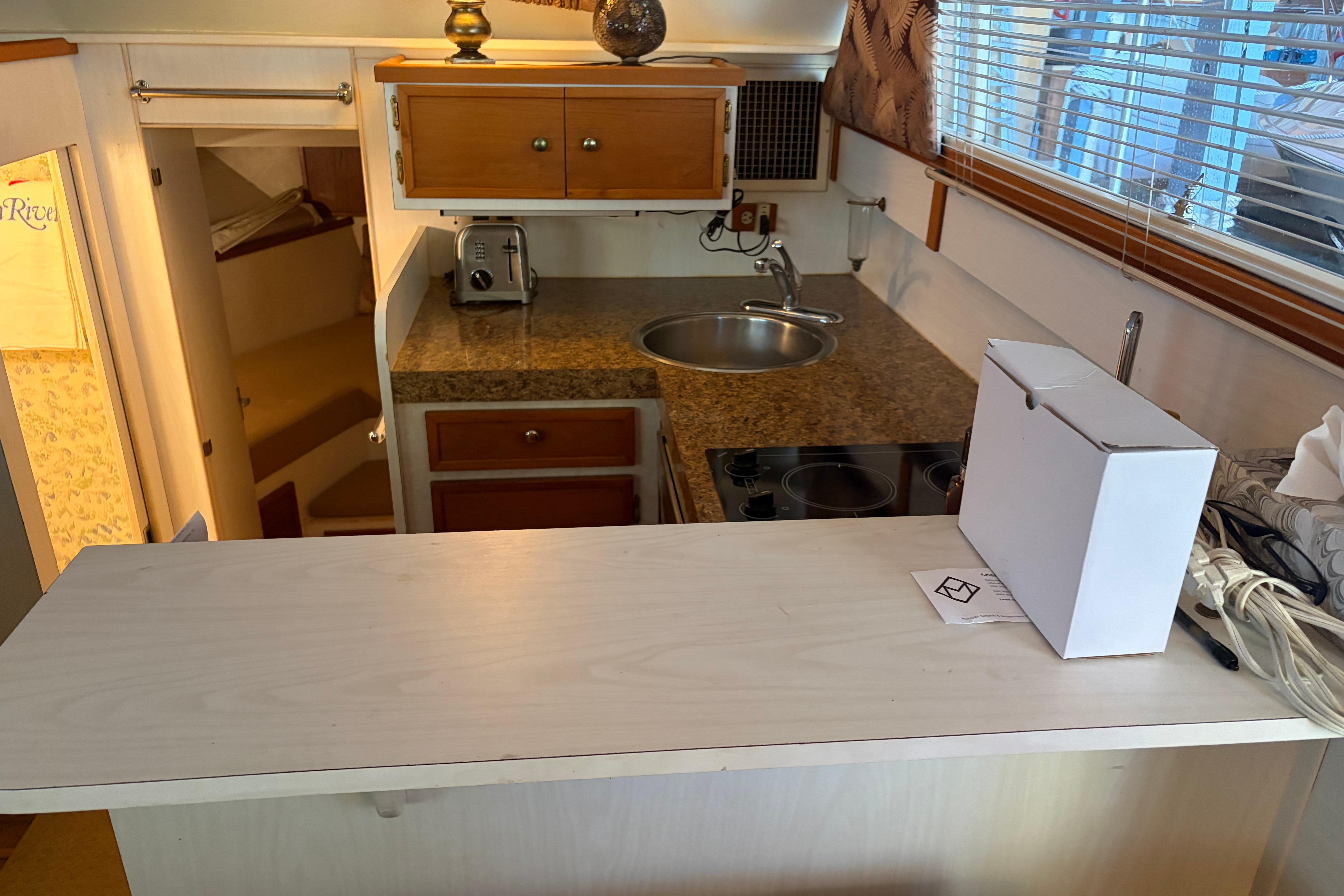 1971 Chris-Craft 42 Commander kitchen with countertop, sink, and stove.