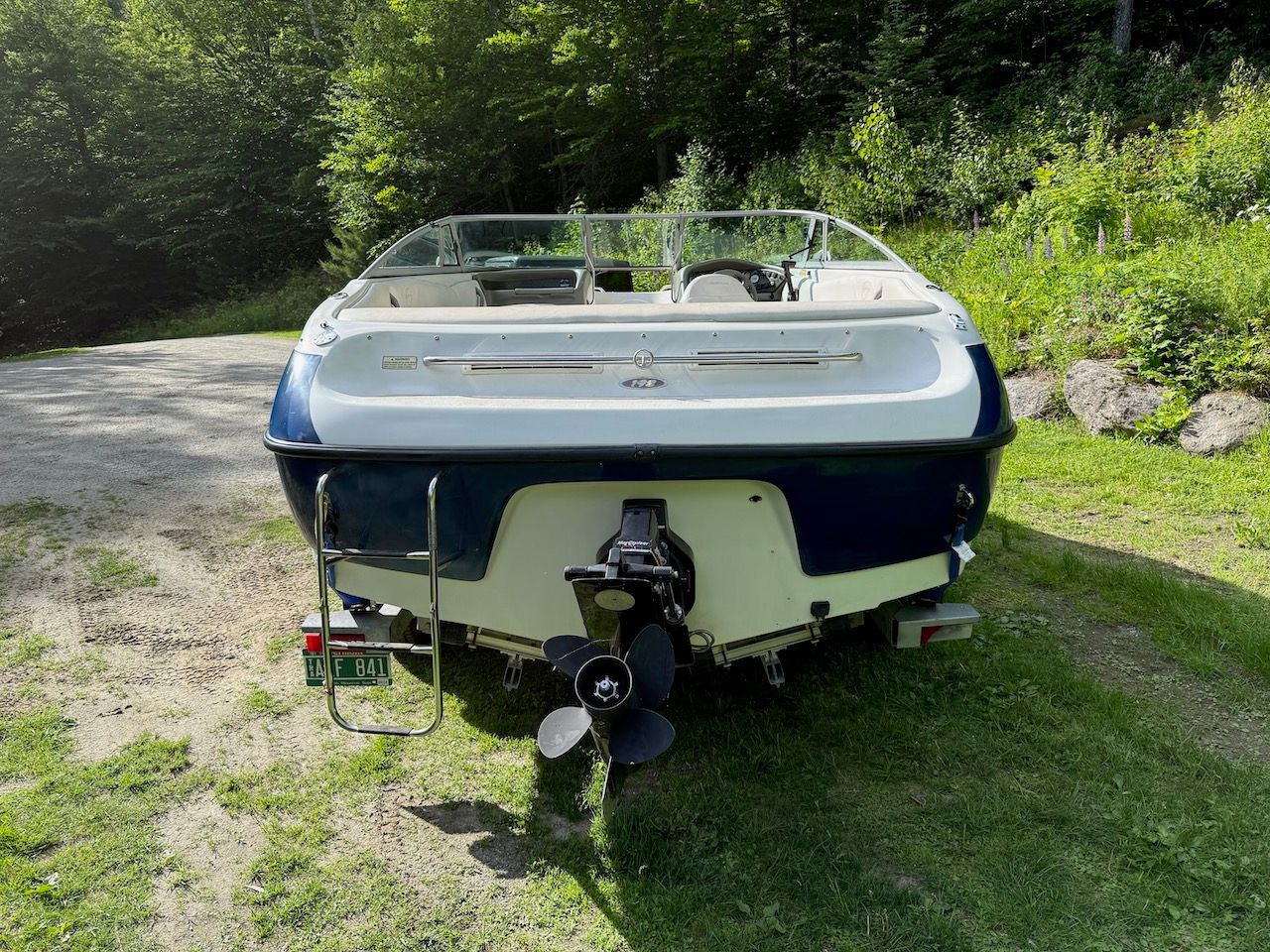 2000 Crownline 192 BR boat on a grassy path.