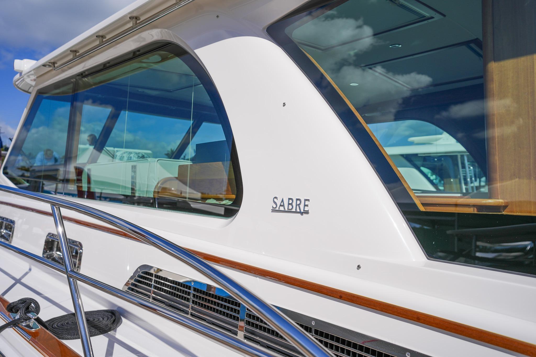 2026 Sabre 51 Salon Express yacht with sleek design and reflective windows.