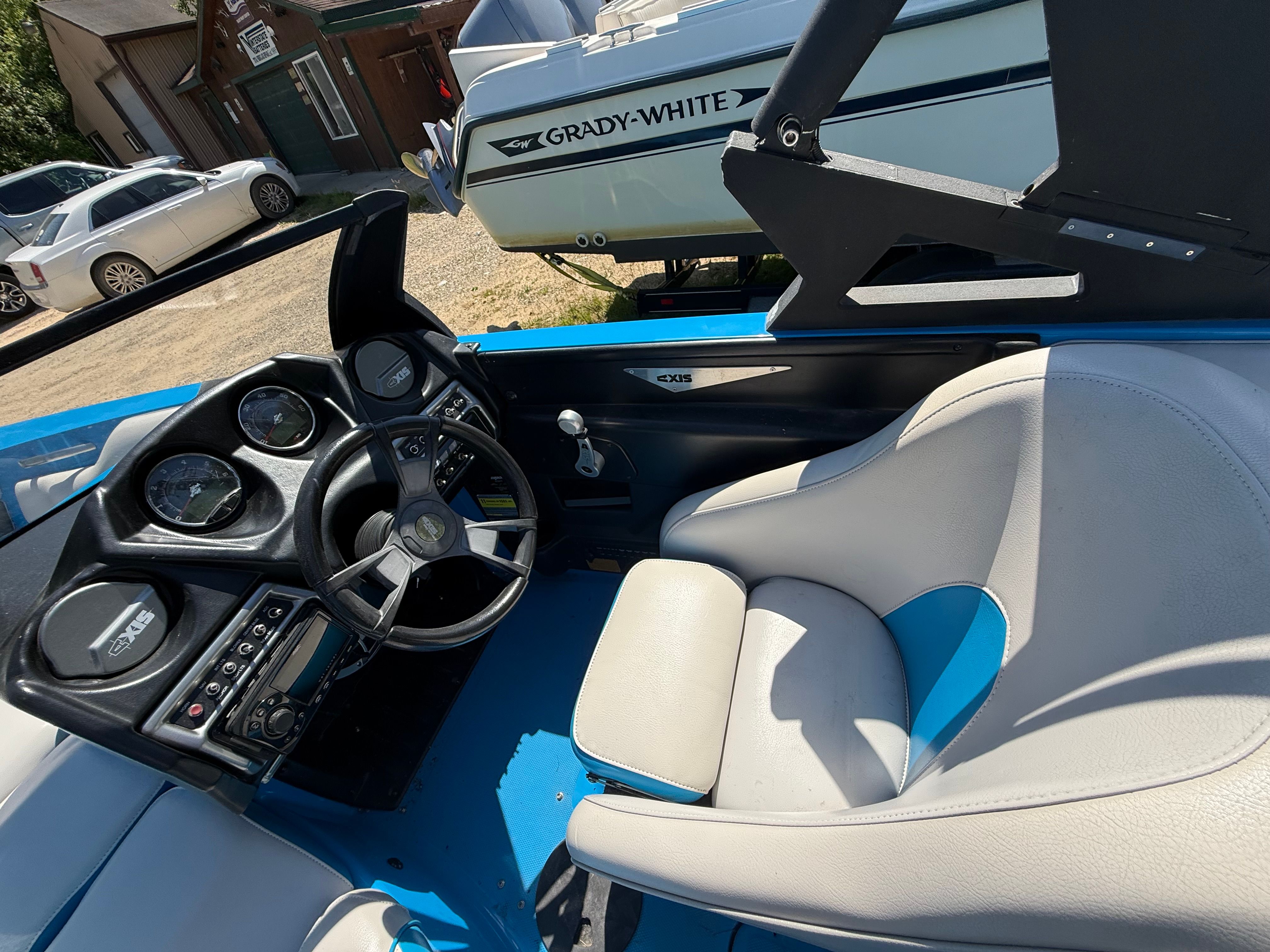 Interior of a 2015 Malibu Axis A20 boat with steering and seats.