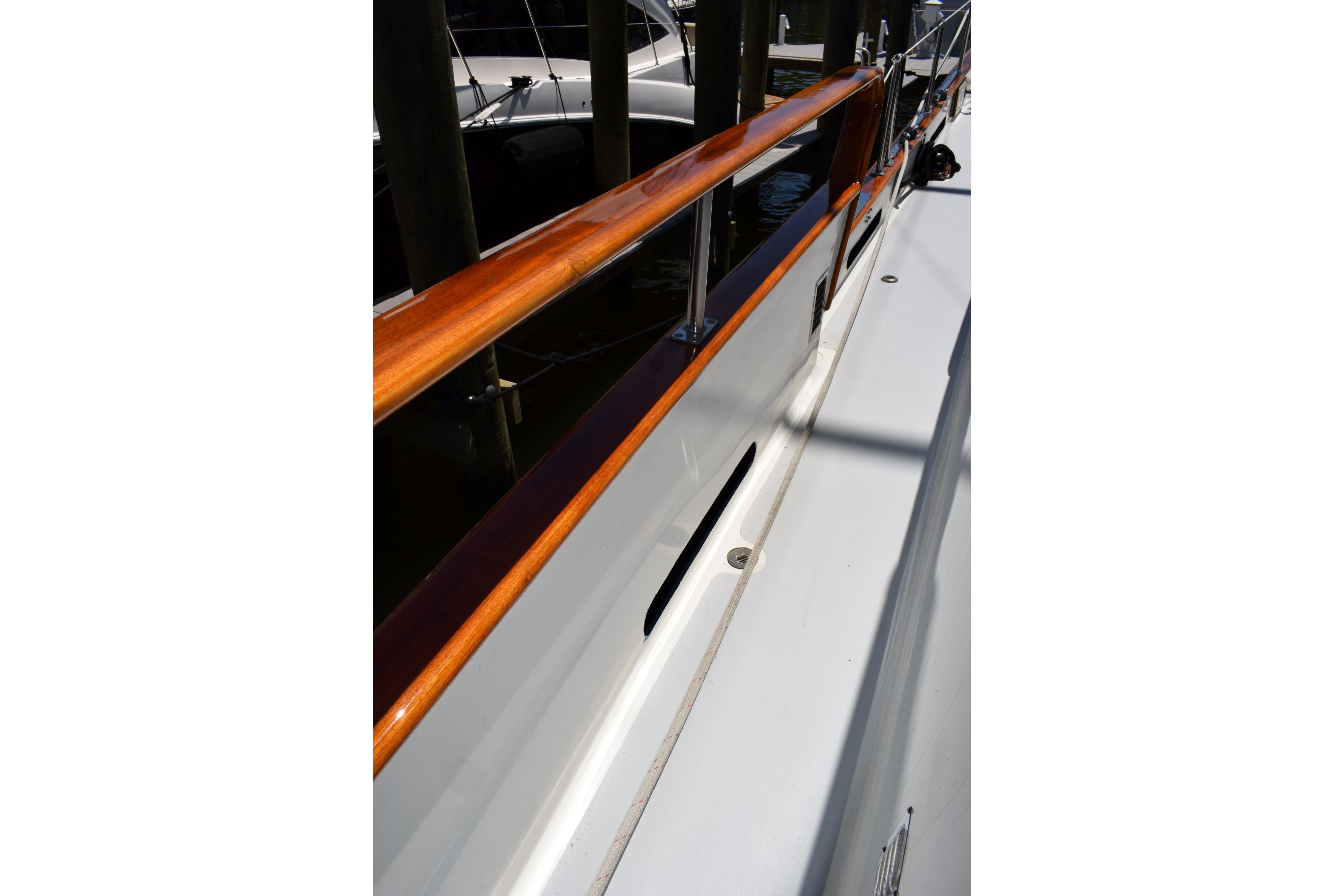 1980 Cheoy Lee 52 Motorsailer deck with polished wood railing.