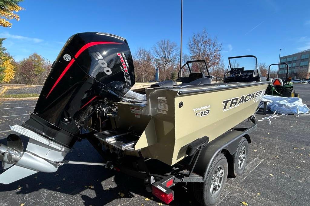 2026 Tracker Targa V-19 Combo boat with powerful outboard motor in a parking lot.