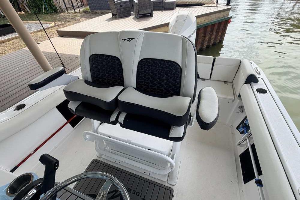2024 Tidewater 232 LXF boat interior with dual seats and steering wheel.
