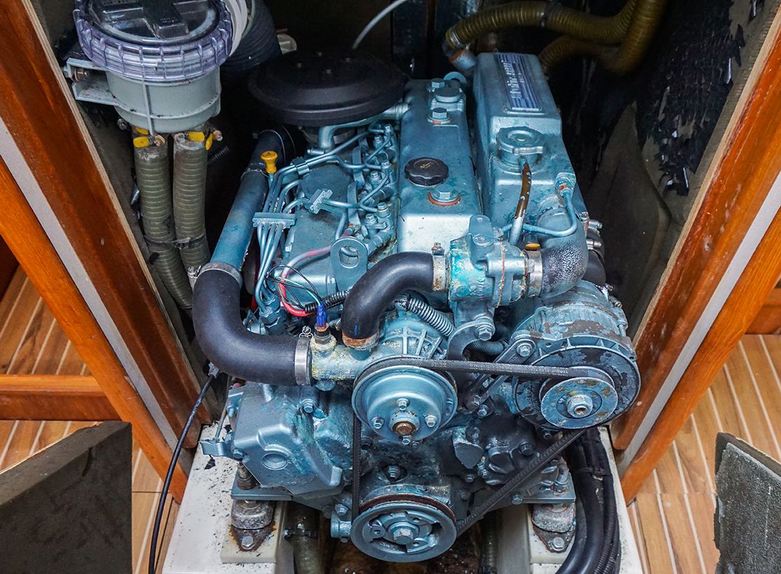 Engine compartment of a 2003 Jeanneau Sun Odyssey 49 with visible engine and hoses.
