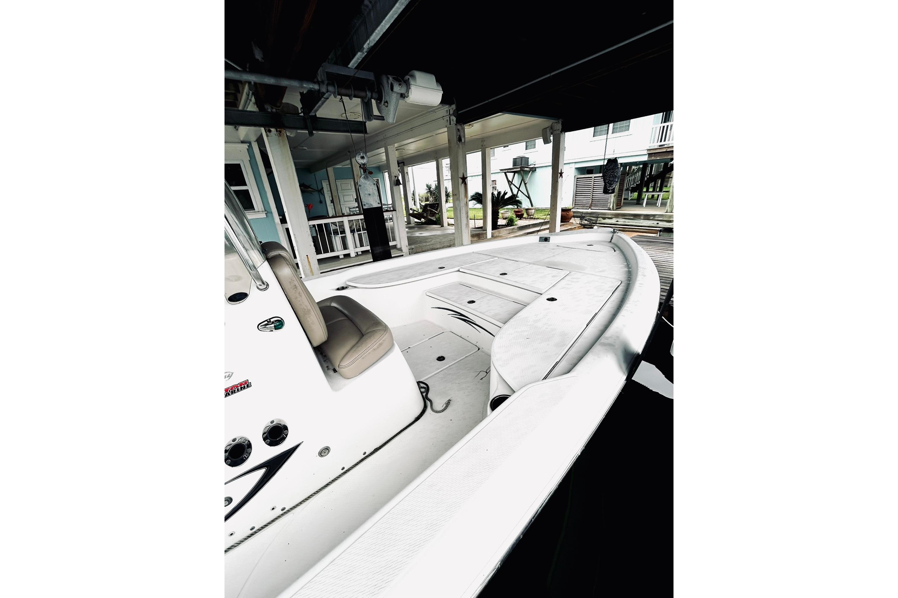 2017 Blue Wave 2200 PureBay boat docked under a covered structure.