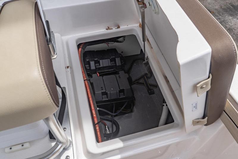 2023 Yamaha Boats 195 FSH Sport battery compartment with seat detail.