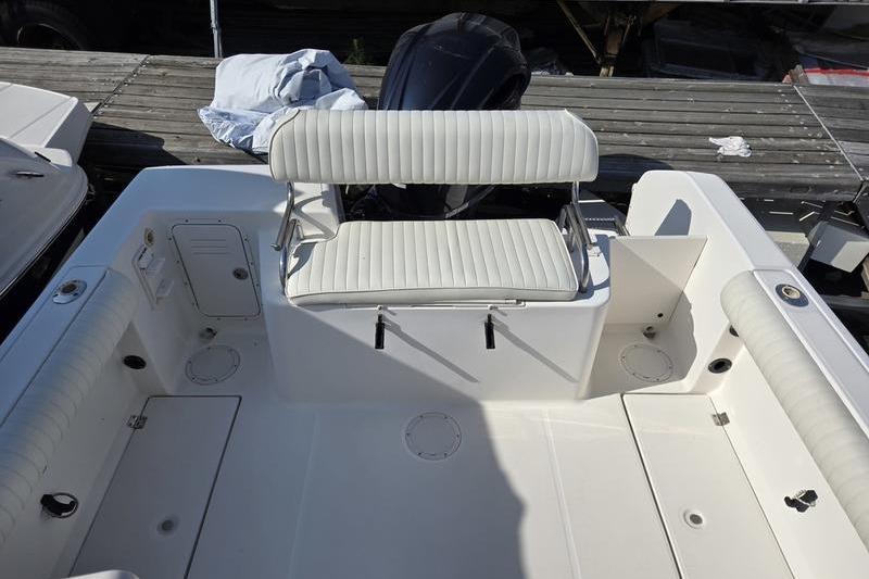 2004 Robalo R235 Walkaround boat interior with white seating and storage compartments.