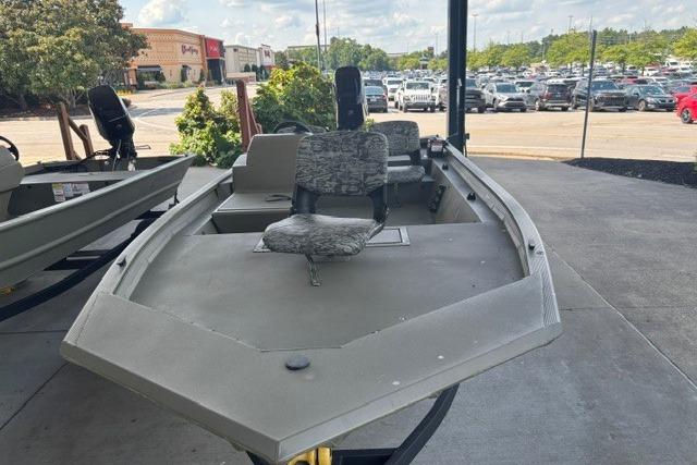 2026 Tracker Grizzly 1754 SC boat displayed outdoors in a parking lot.