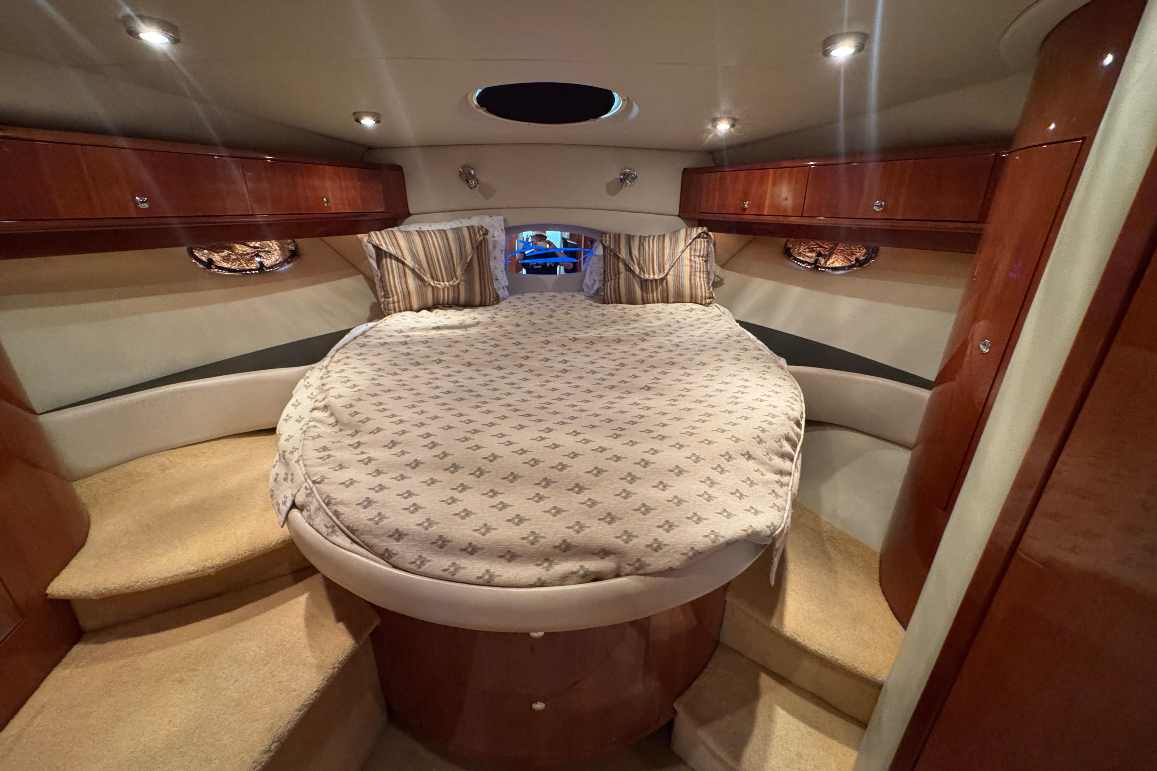 Luxurious cabin interior of 2005 Regal Commodore 4260 yacht with cozy bedding.