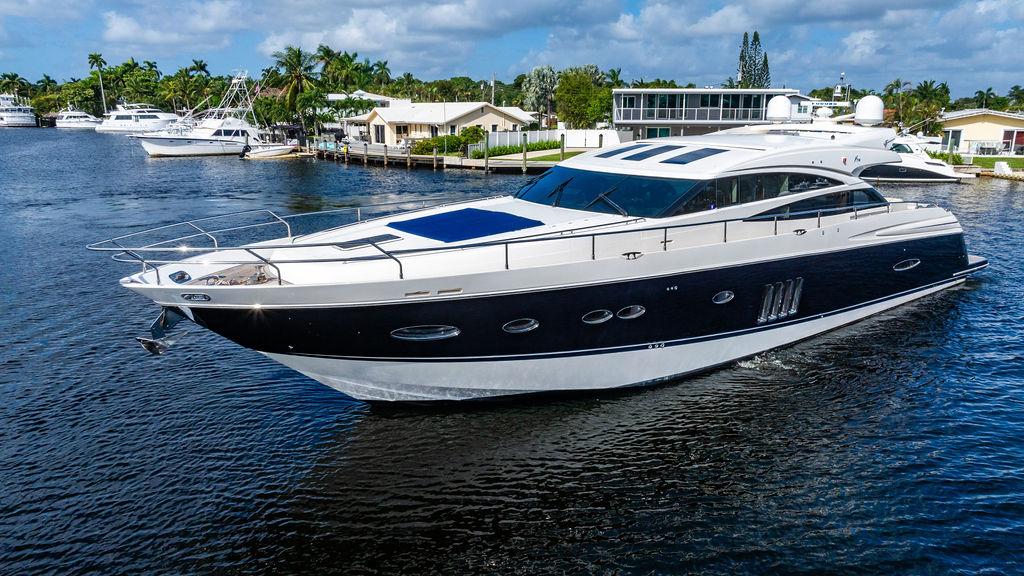 Luxurious 2010 Princess V78 yacht cruising on a serene waterway.