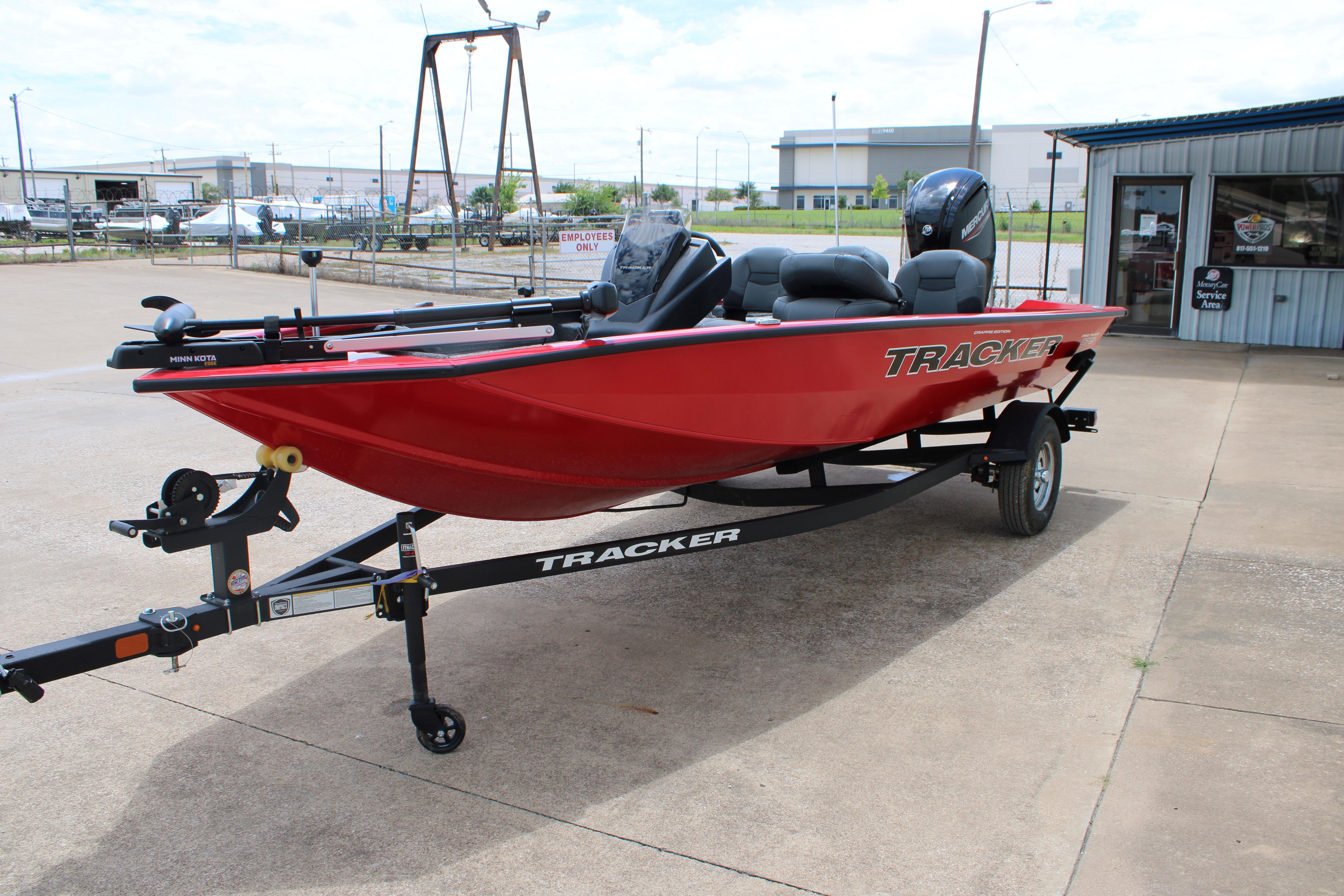 2026 Tracker Pro Team 175 Crappie Edition boat on trailer, parked outdoors.
