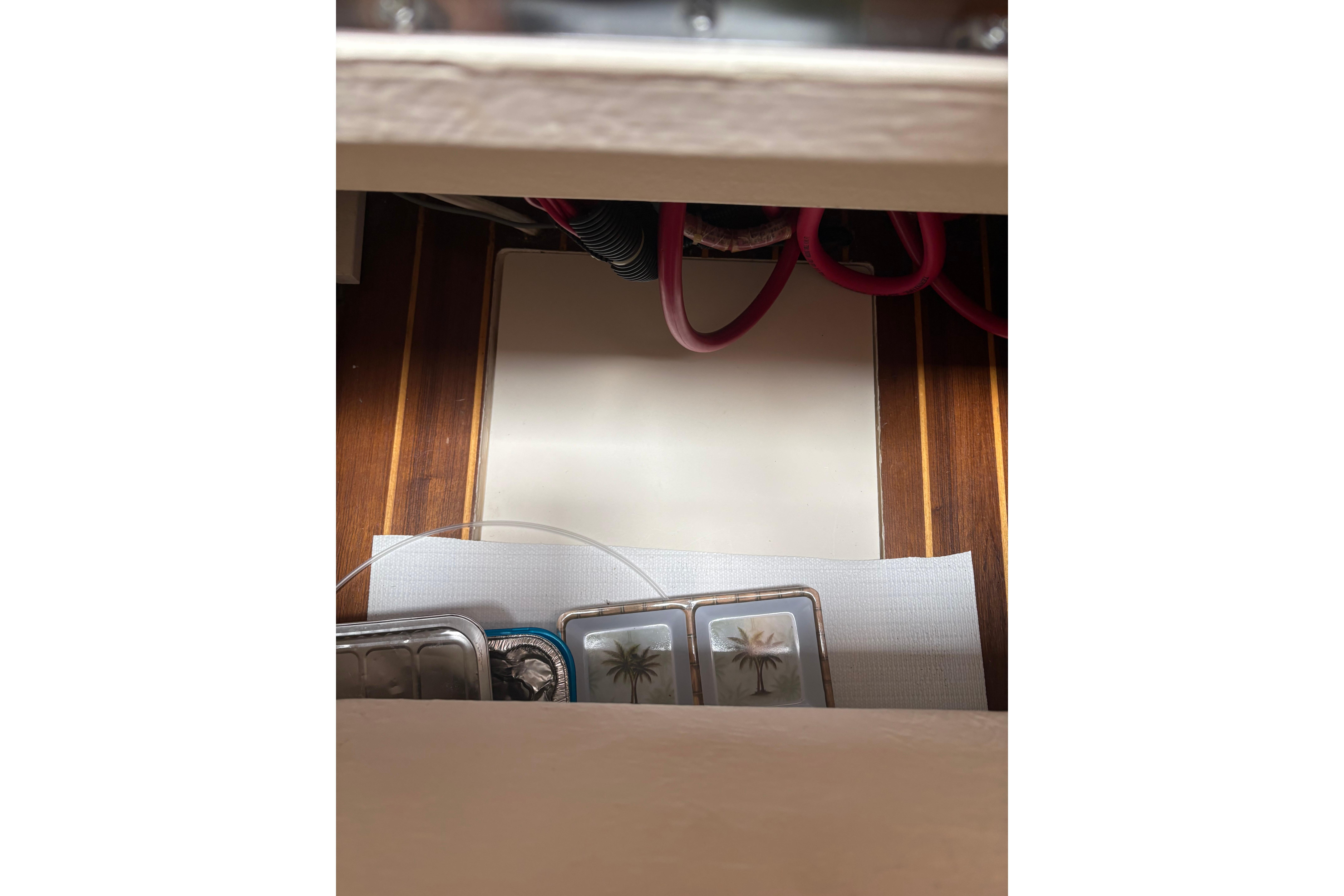 Interior view of a 1999 Tiara Yachts 3100 Open, showcasing storage area and wiring.