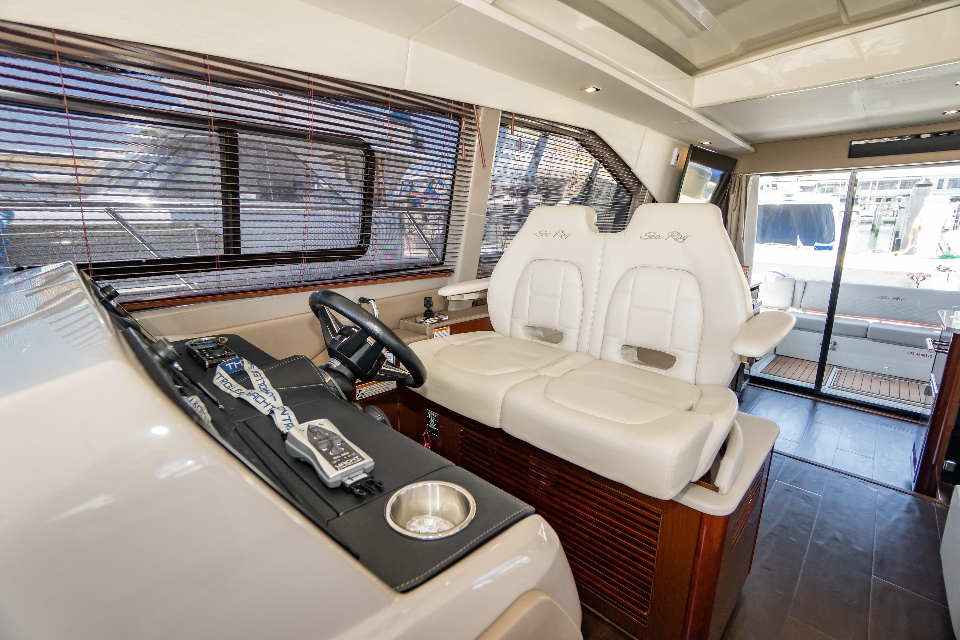 2017 Sea Ray Sundancer 460 helm with plush seating and modern controls.