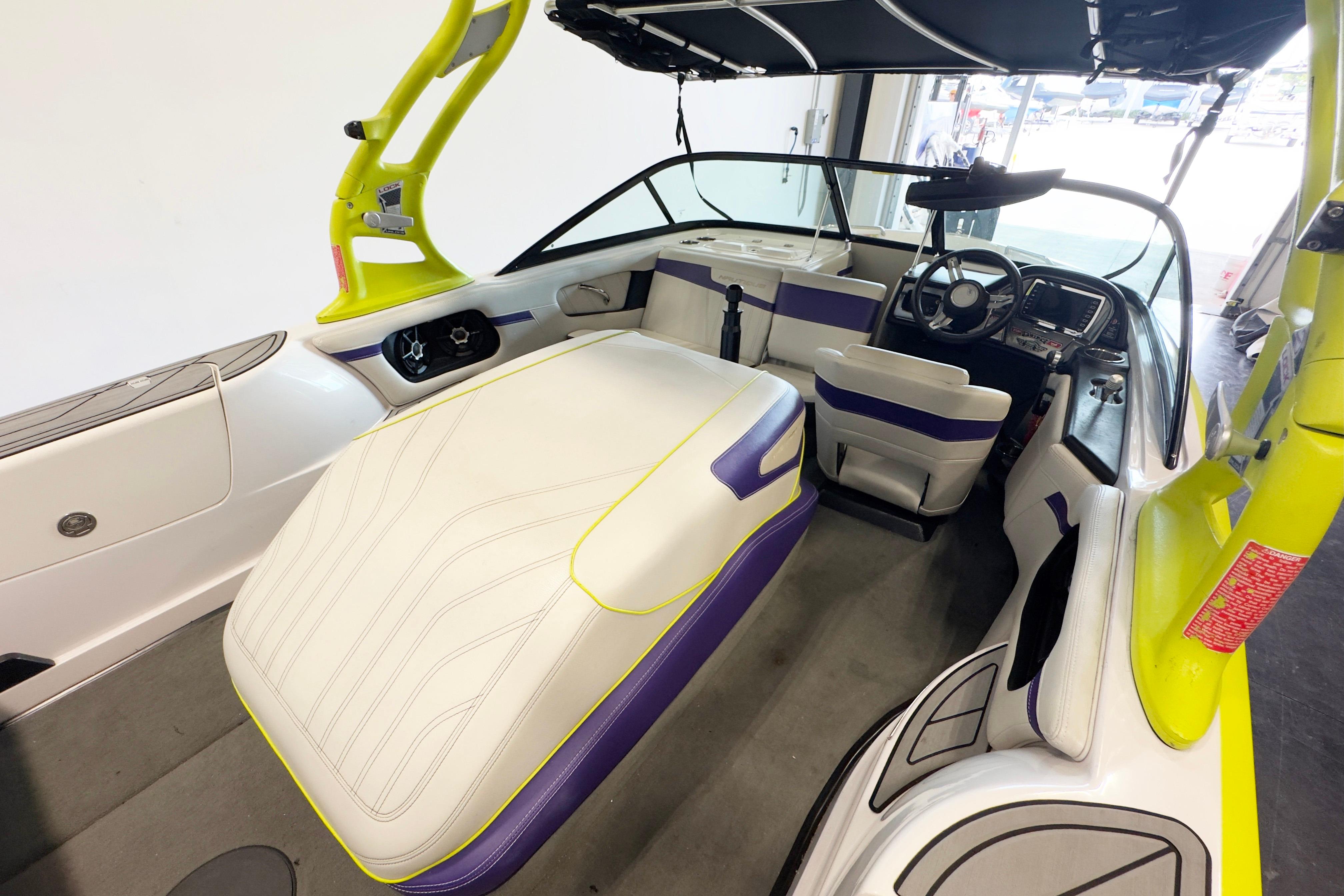 2014 Nautique Ski Nautique 200 Closed Bow interior with vibrant yellow and purple accents.
