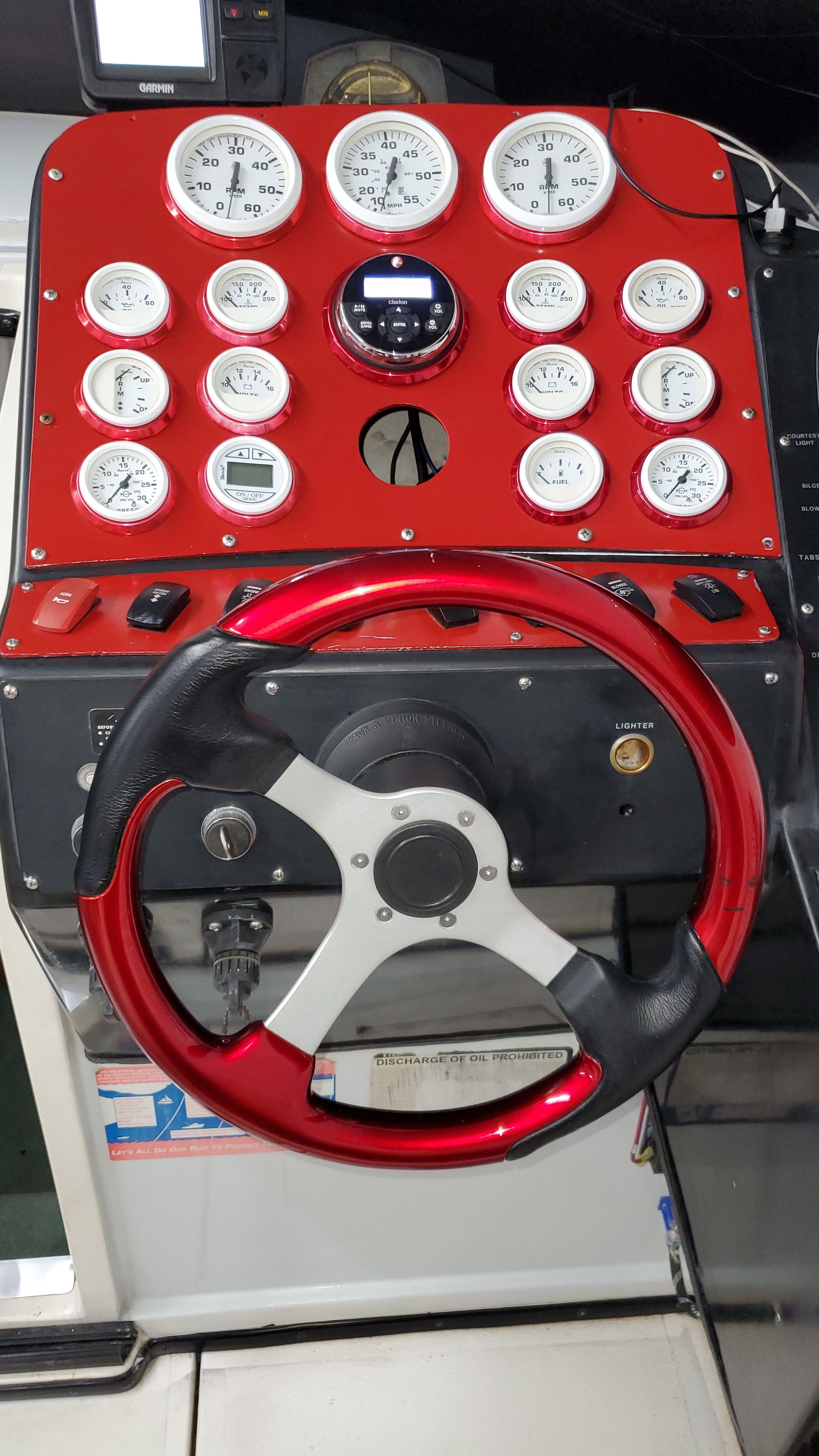 Dashboard of a 1989 Baja 280 Sport boat with red steering wheel.