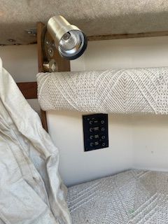 Interior of a 1986 Wellcraft Starwind 19 with a lamp and control panel.