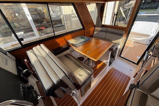 Interior of a 2019 Cutwater 28 boat with seating and wooden table.
