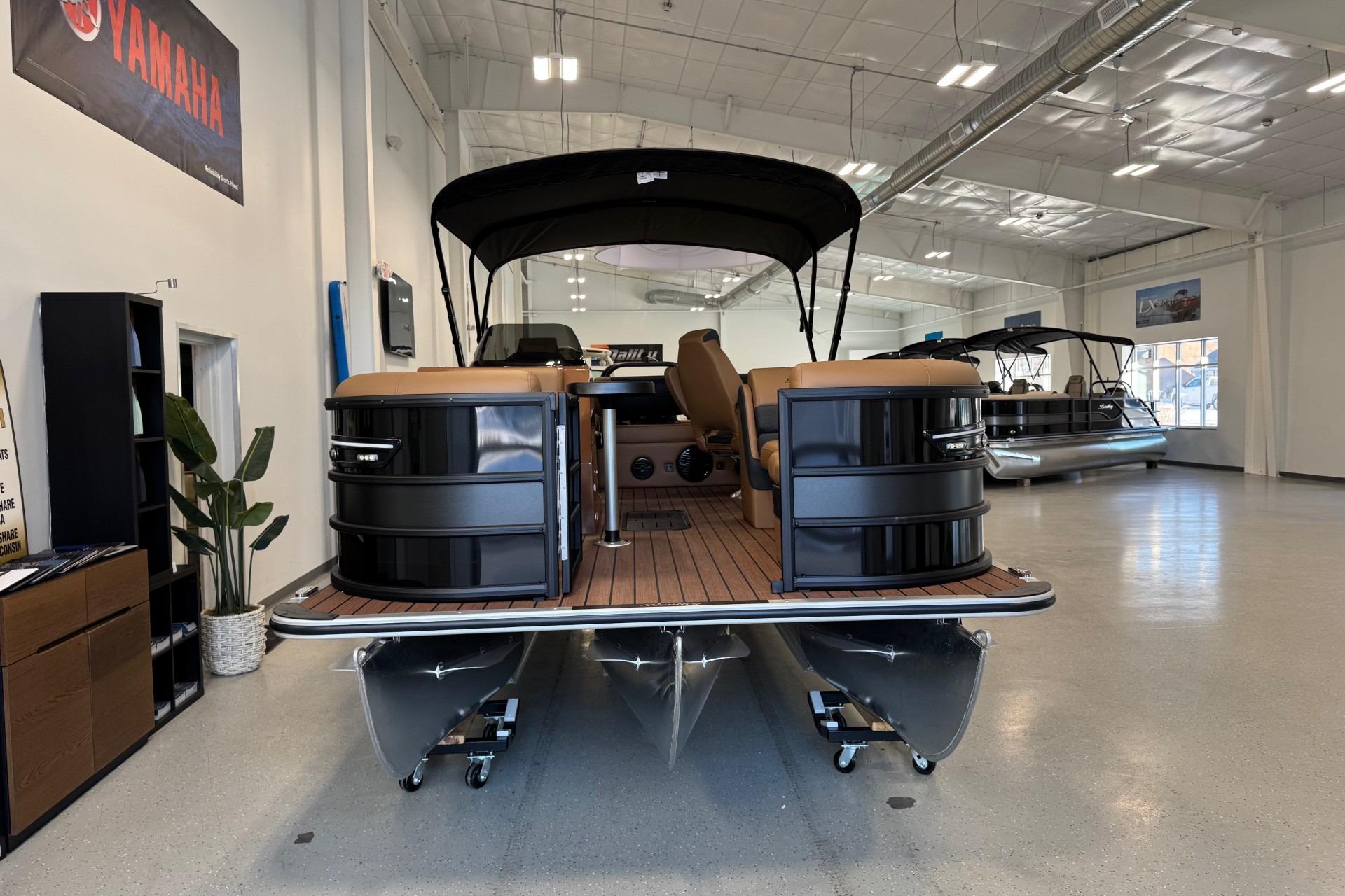 2026 Bentley Pontoons Elite 223 Swingback displayed in a showroom with sleek design.
