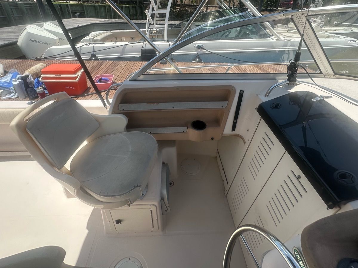 The image shows the cockpit of a 1998 Grady-White Adventure 208 boat. It features a seat and helm.
