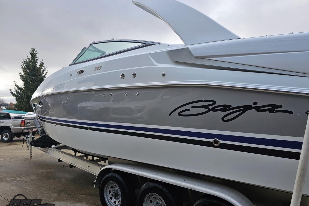 2008 Baja 335 Performance boat on trailer, showcasing sleek design and branding.