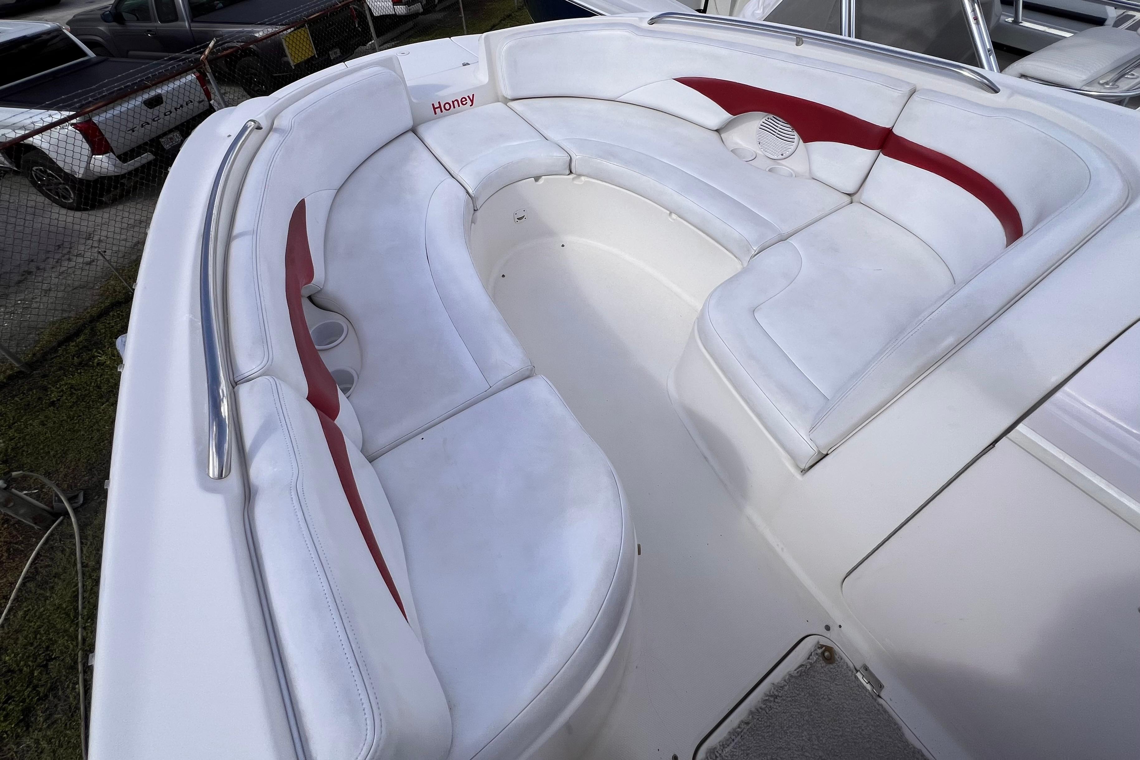 2002 Chaparral 232 Sunesta boat interior with white and red cushioned seating.