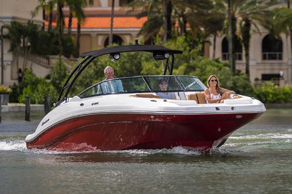 Manufacturer Provided Image: 2026 Hurricane SunDeck 2690 OB cruising on water with passengers, surrounded by lush greenery.