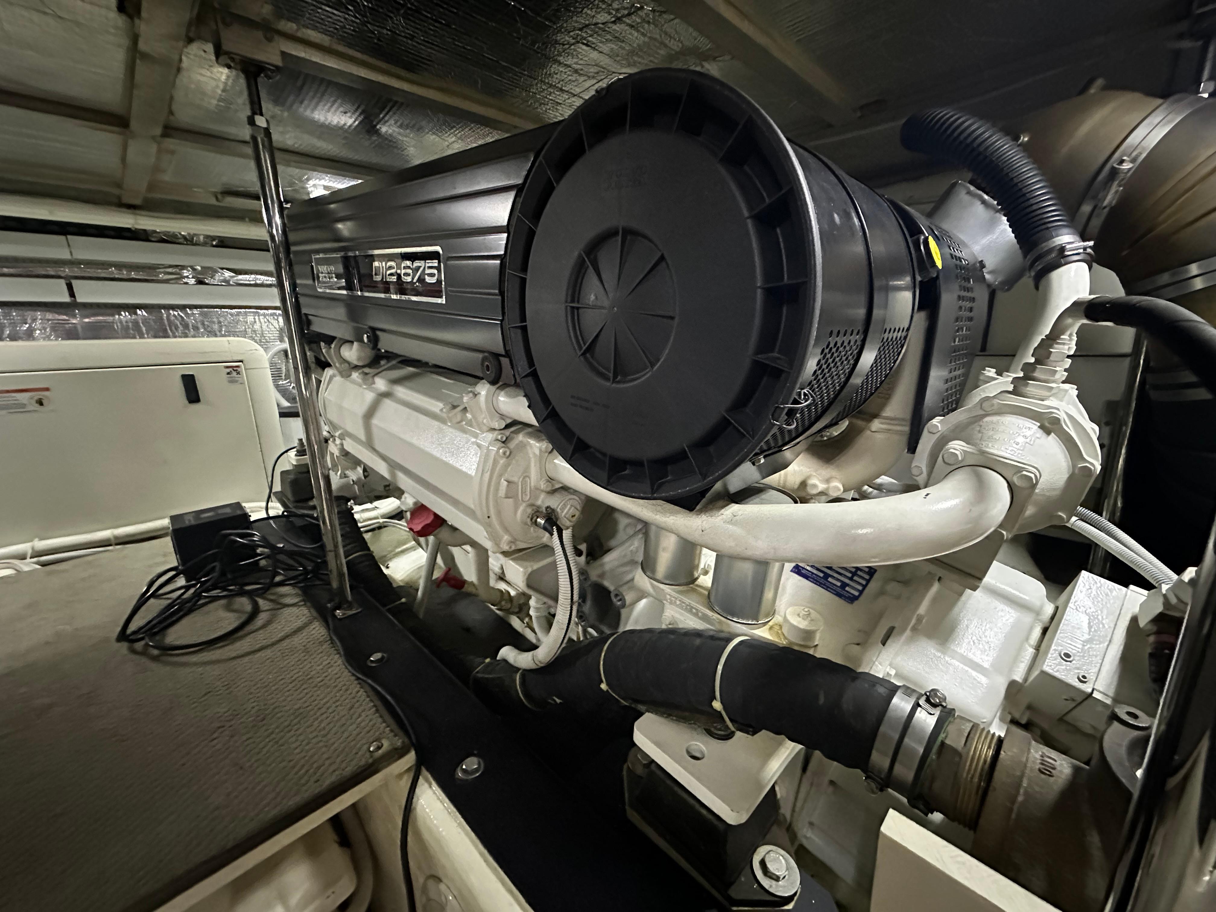 Engine room of 2005 Carver 56 Voyager yacht, featuring a powerful diesel engine.