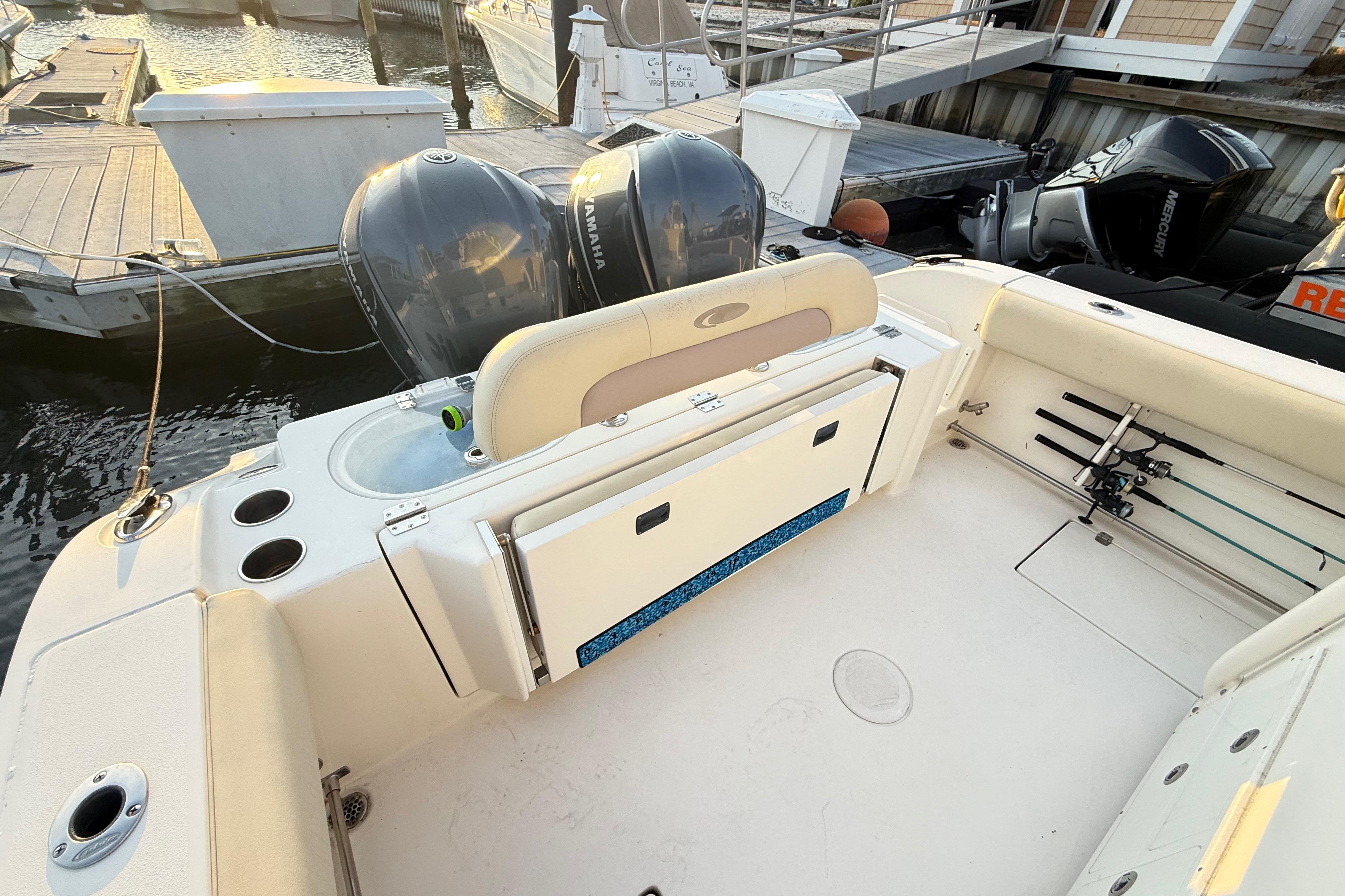 2016 Cobia 296 Center Console boat with dual Yamaha engines at dock.