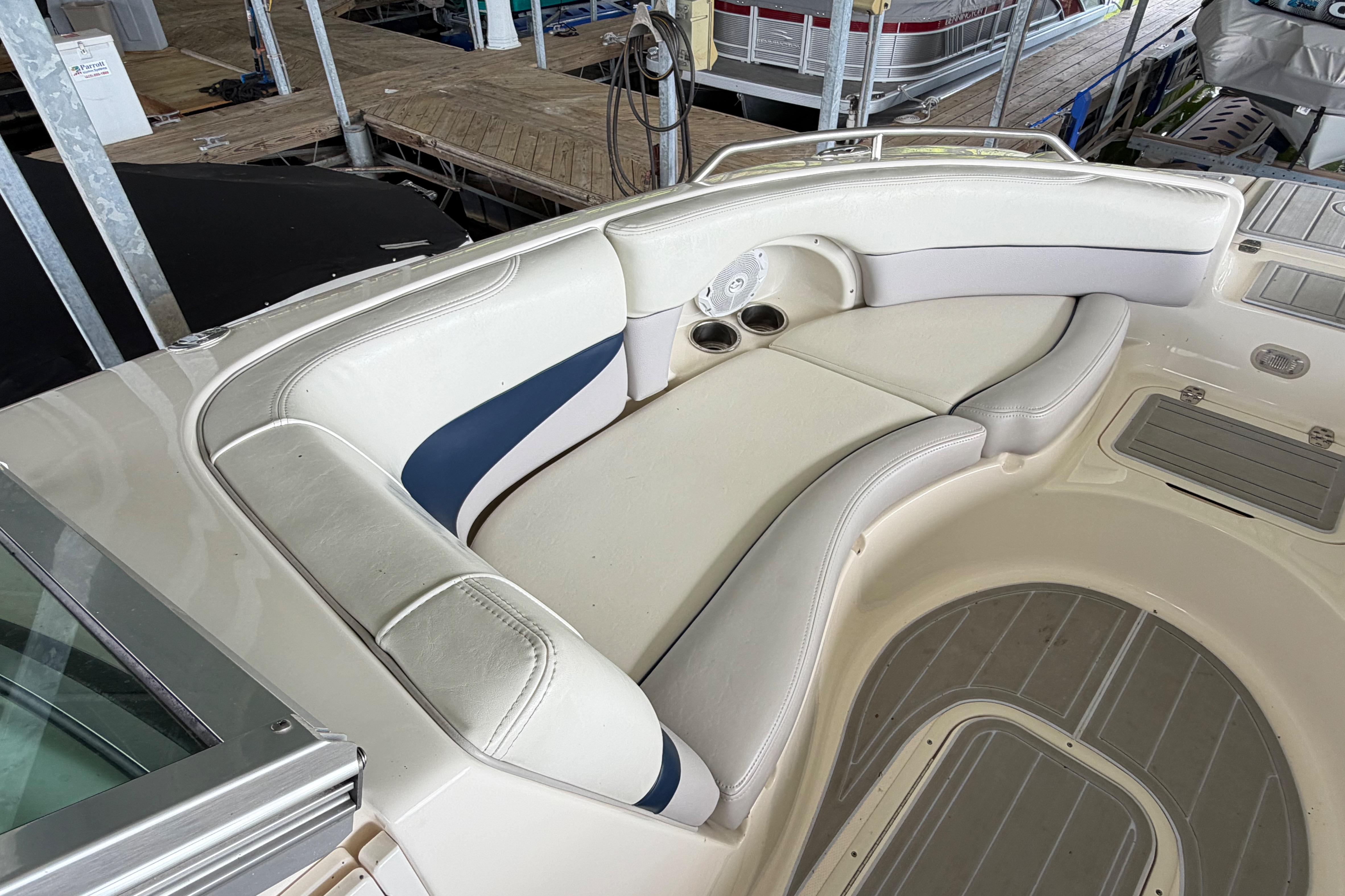 2010 Bryant 255 boat interior with white and blue seating, docked at marina.
