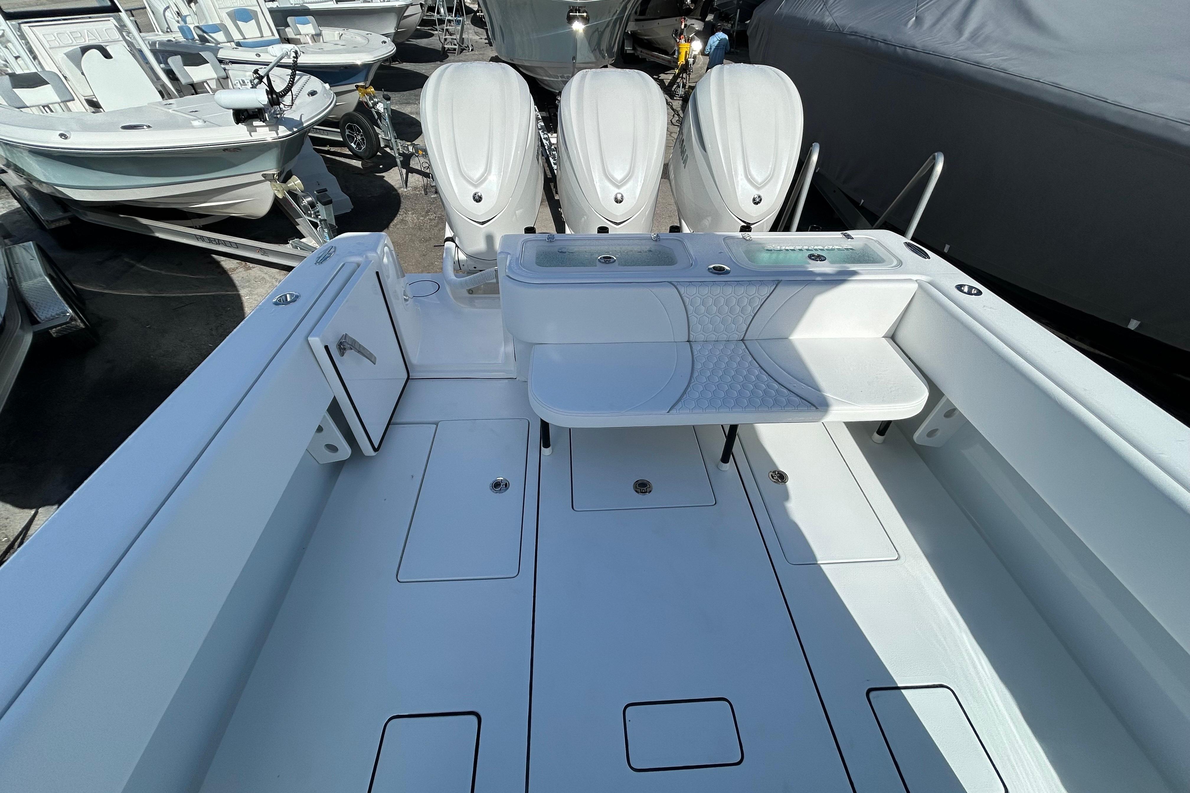 2026 Contender 35 ST boat interior with triple outboard engines, spacious deck, and seating area.