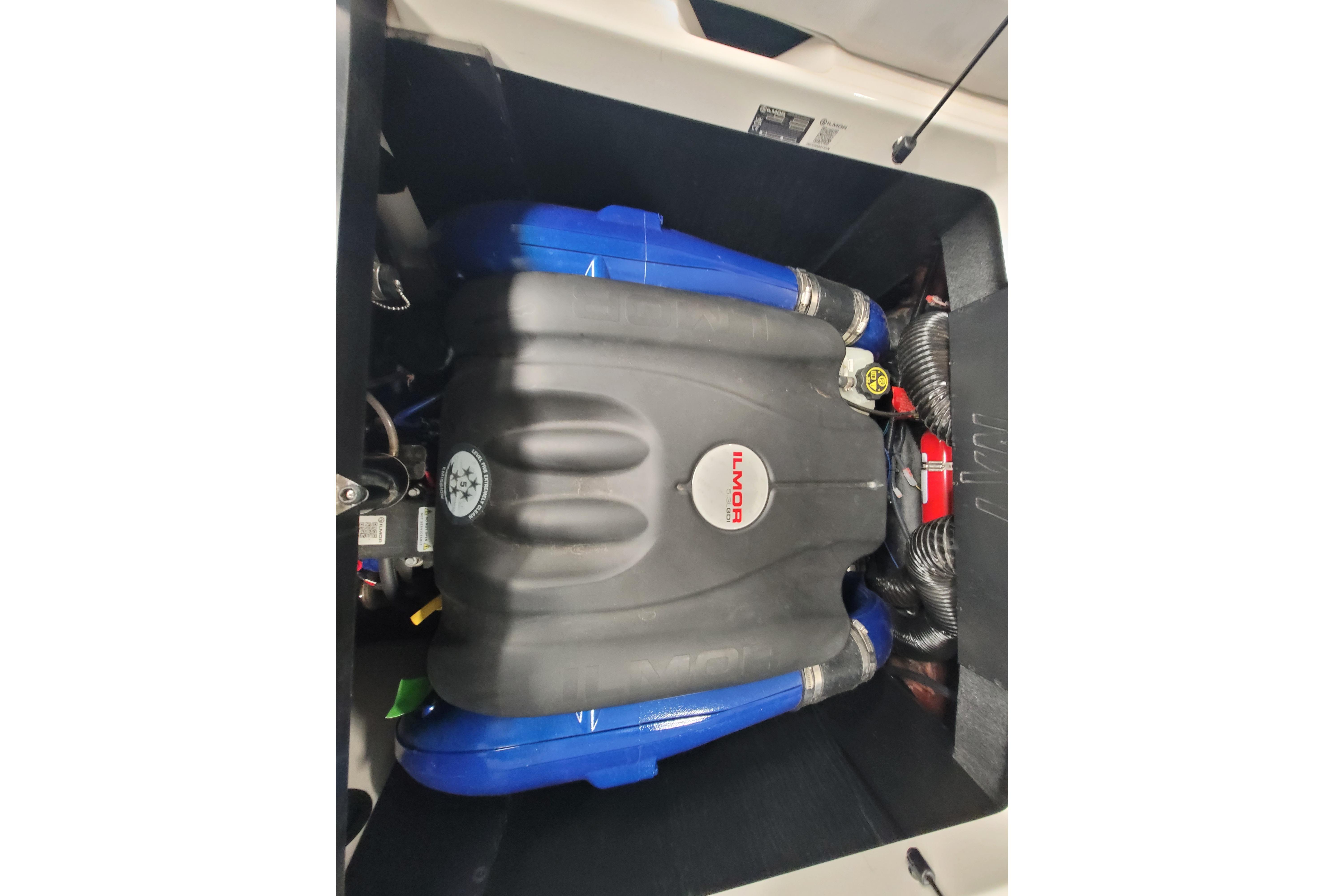 2024 MasterCraft NXT24 engine compartment with Ilmor engine, featuring blue and black components.
