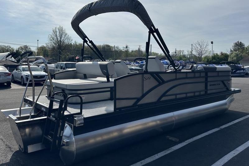 2026 Bennington S Swingback 22 SSB pontoon boat in parking lot, side view.