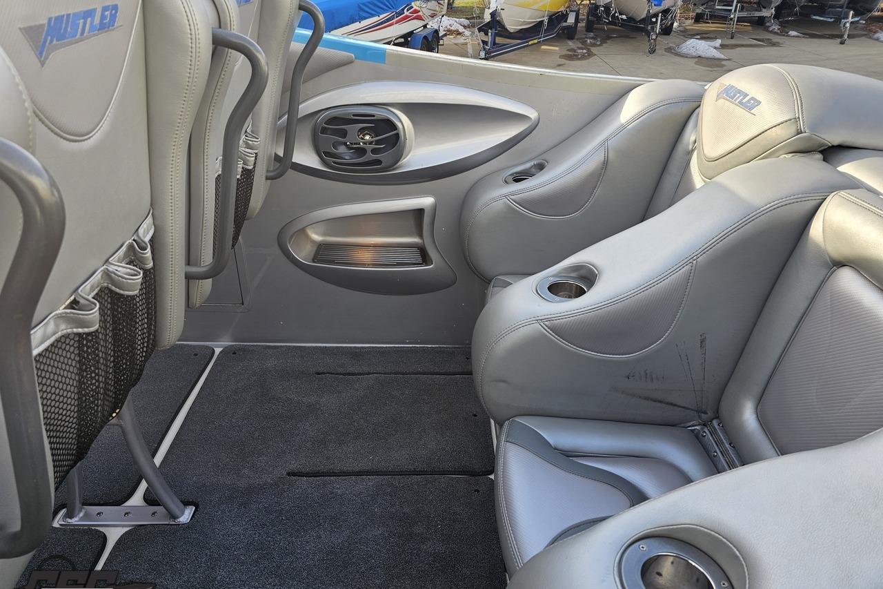Interior of 2007 Hustler 41 Razor boat with gray leather seats and cup holders.