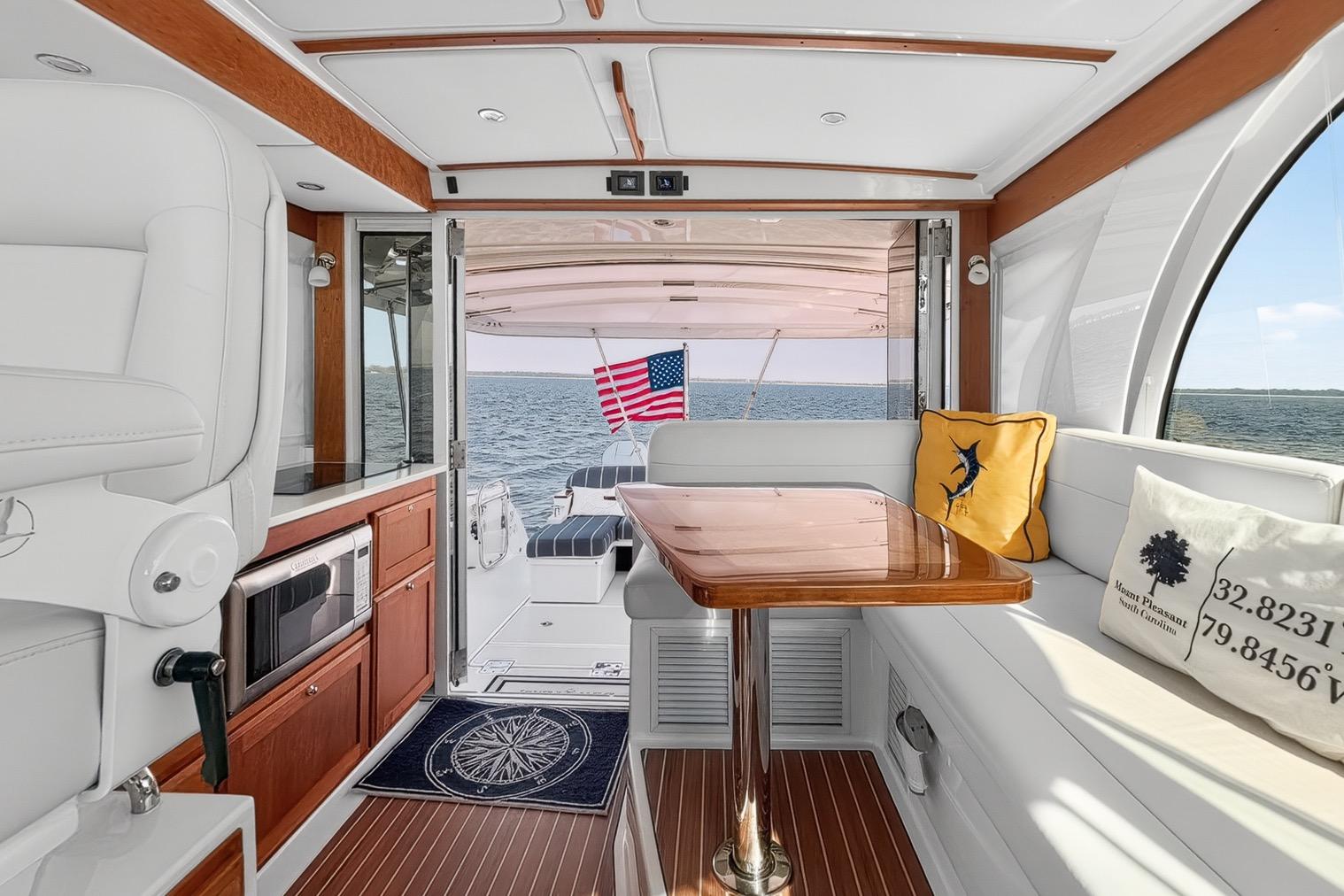 Luxurious interior of 2024 Back Cove 39O yacht with open enclosure, 360 degree view and elegant seating.