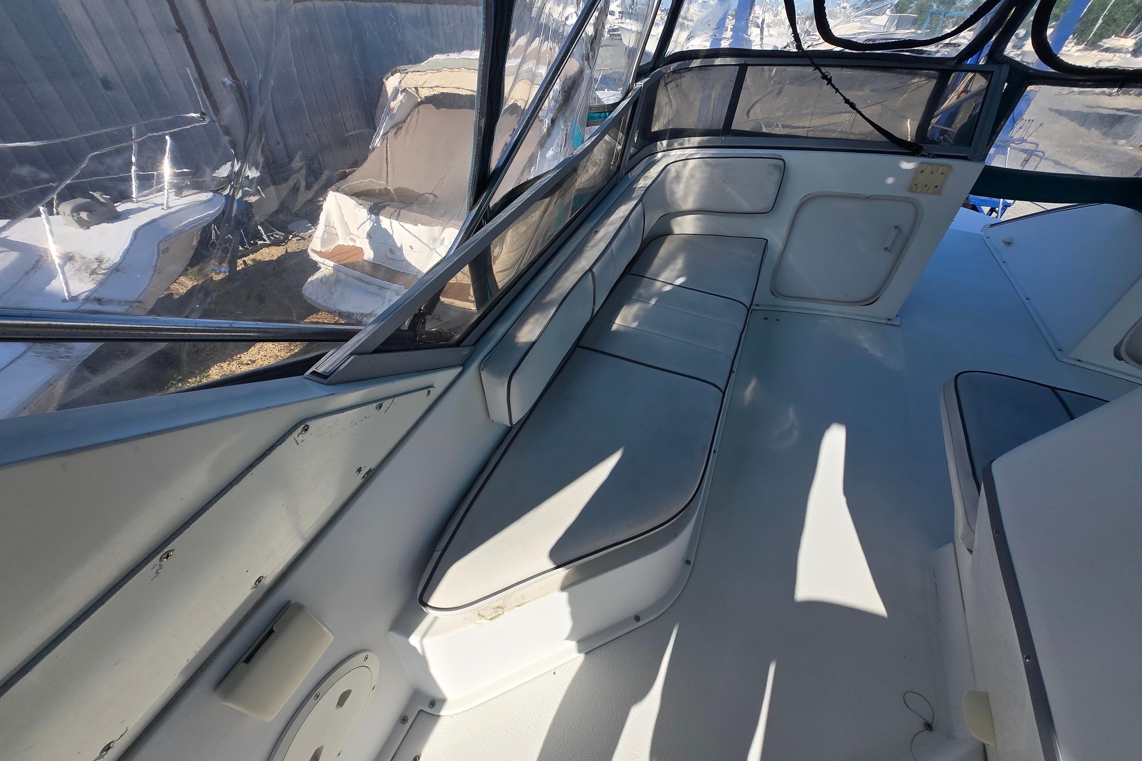 Interior view of a 1994 Carver 380 Santego boat with seating and windows.