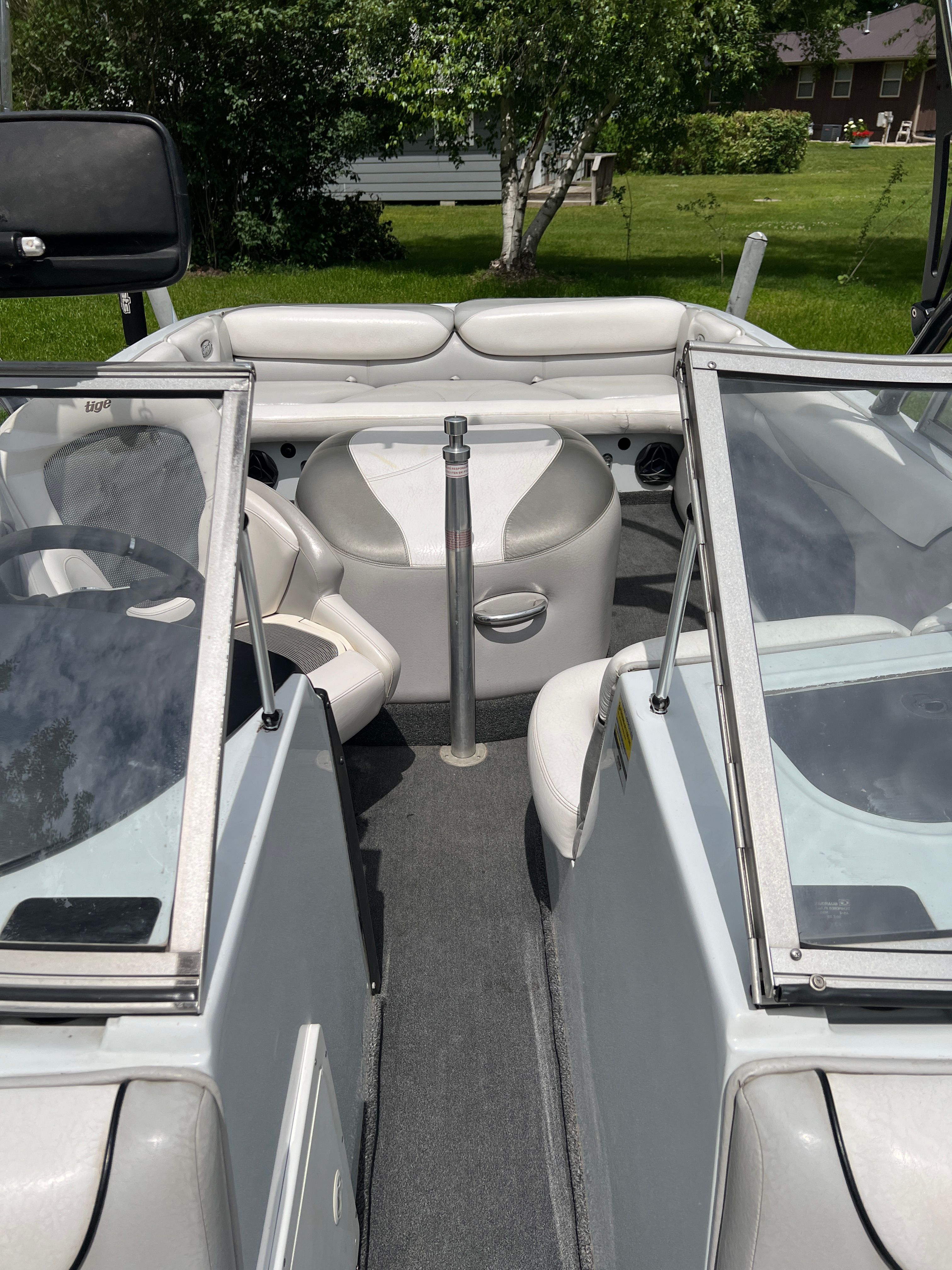 Interior view of a 2006 Tigé 20i boat with white seating and gray carpet.