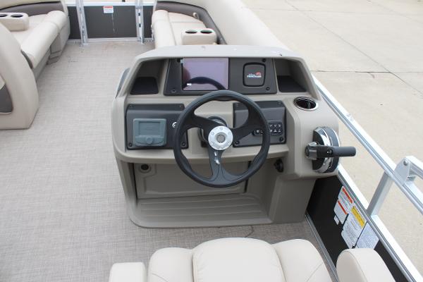 2025 Sun Tracker Party Barge 18 DLX helm with steering wheel and control panel.