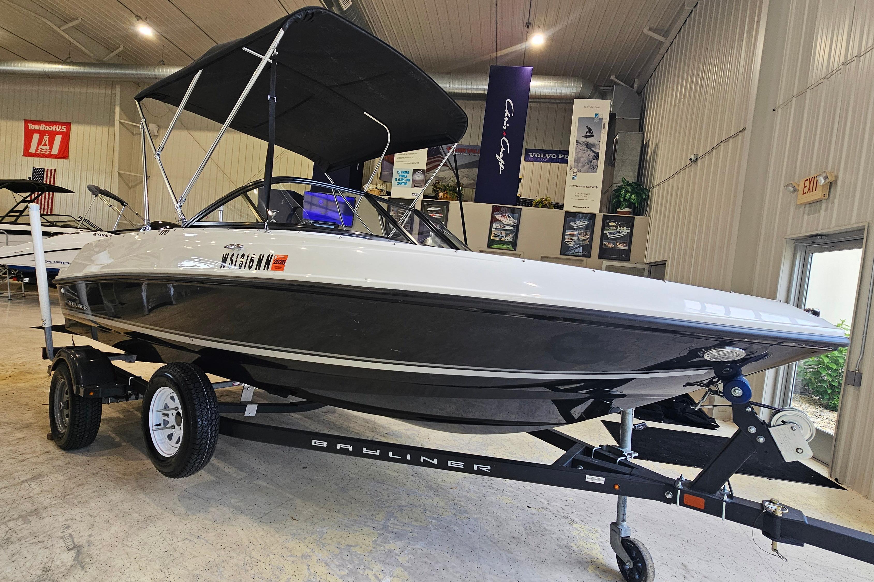 2019 Bayliner 170 Bowrider boat on trailer in showroom, black and white design.