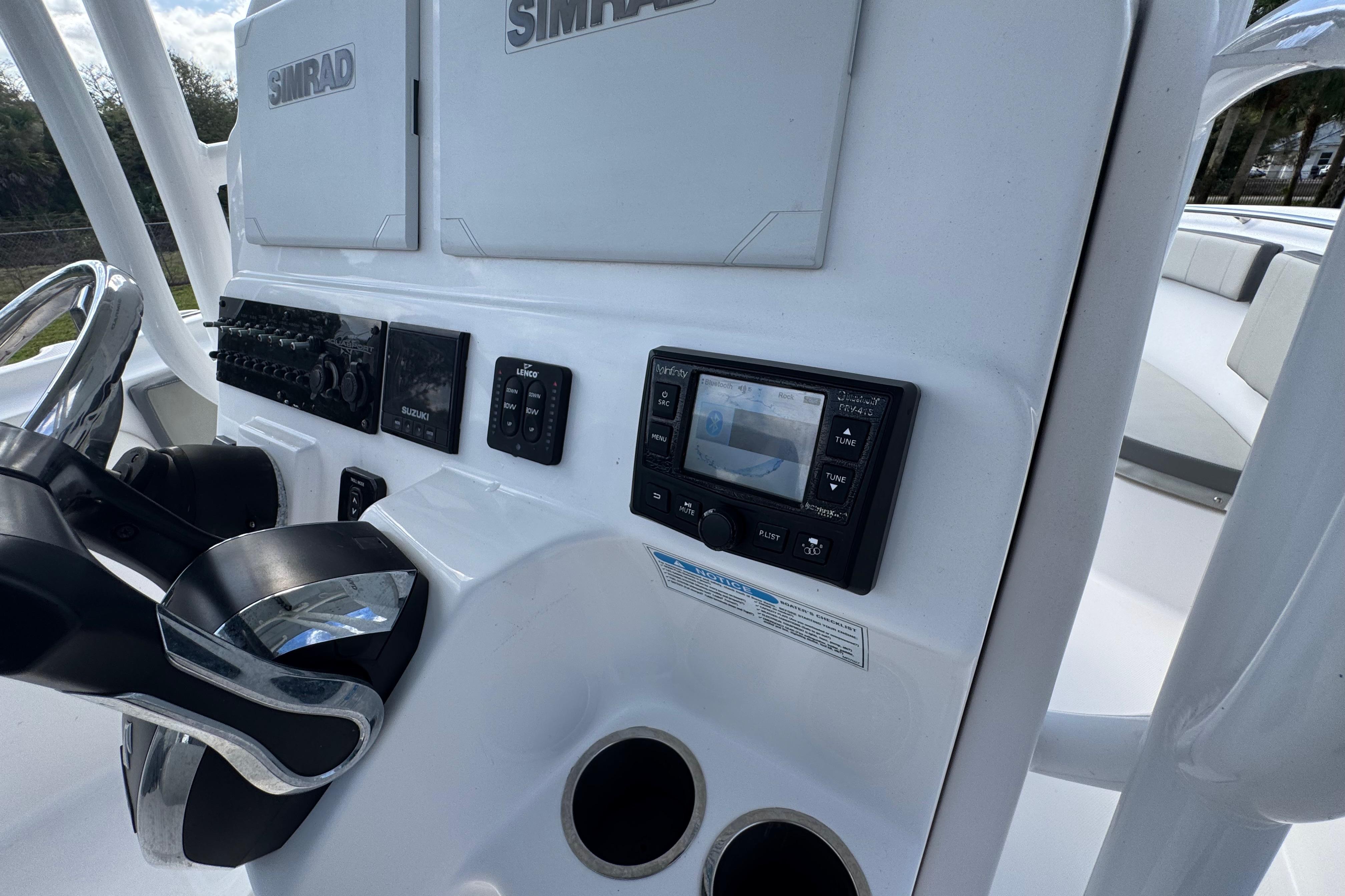 2022 Aquasport 2500 Center Console dashboard with Simrad electronics and steering wheel.