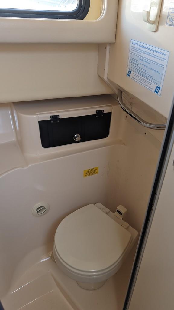 2006 Grady-White Marlin 300 boat bathroom with toilet and storage compartment.