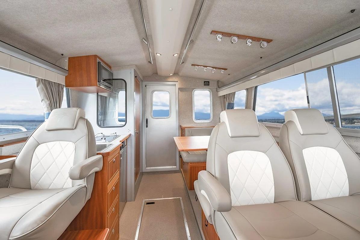 Luxurious interior of 2026 KingFisher 3225 GFX Offshore boat with leather seating and kitchenette.