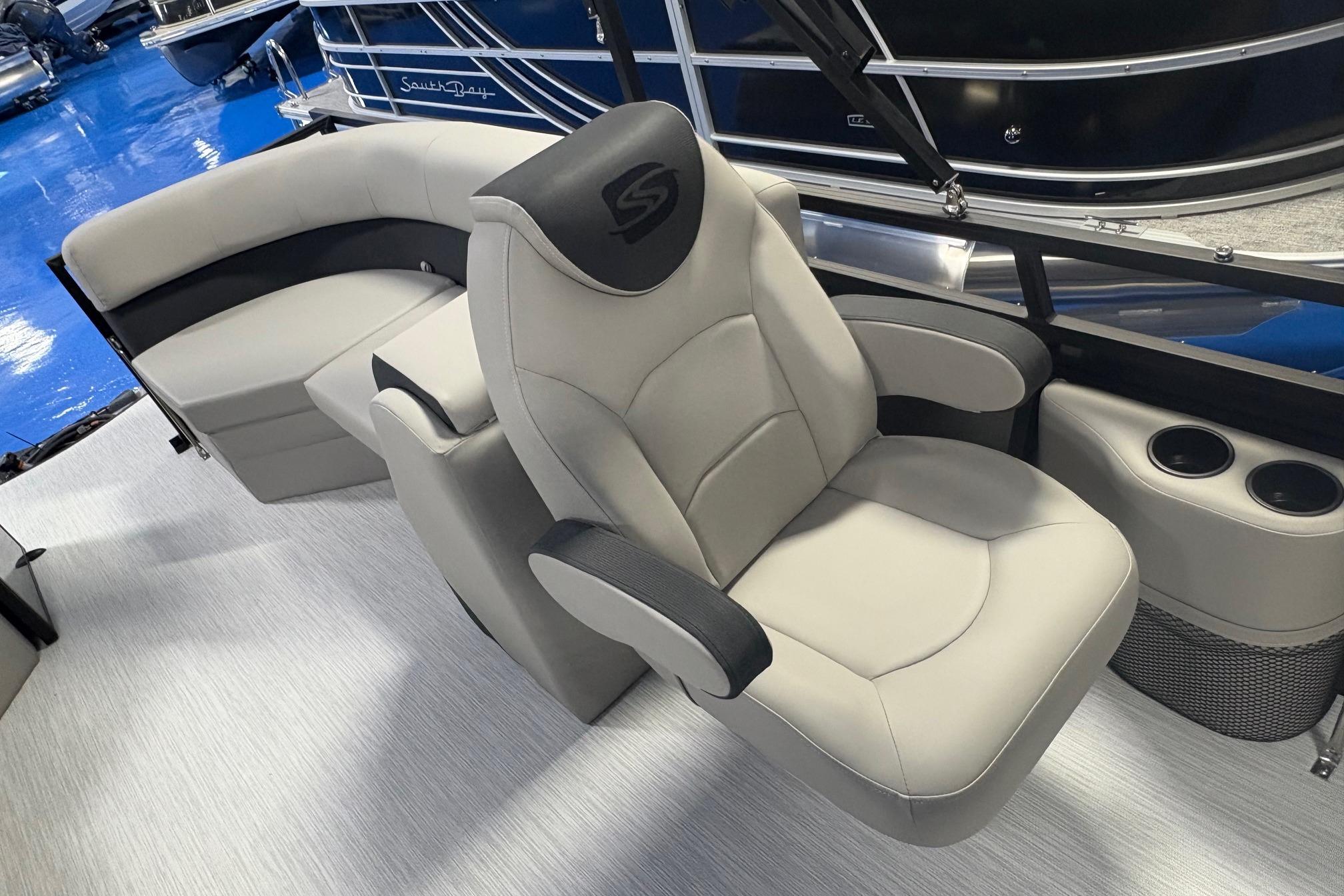 Luxurious seating on Dockside 22DQ boat, 2026 model, featuring plush captain's chair and sofa.