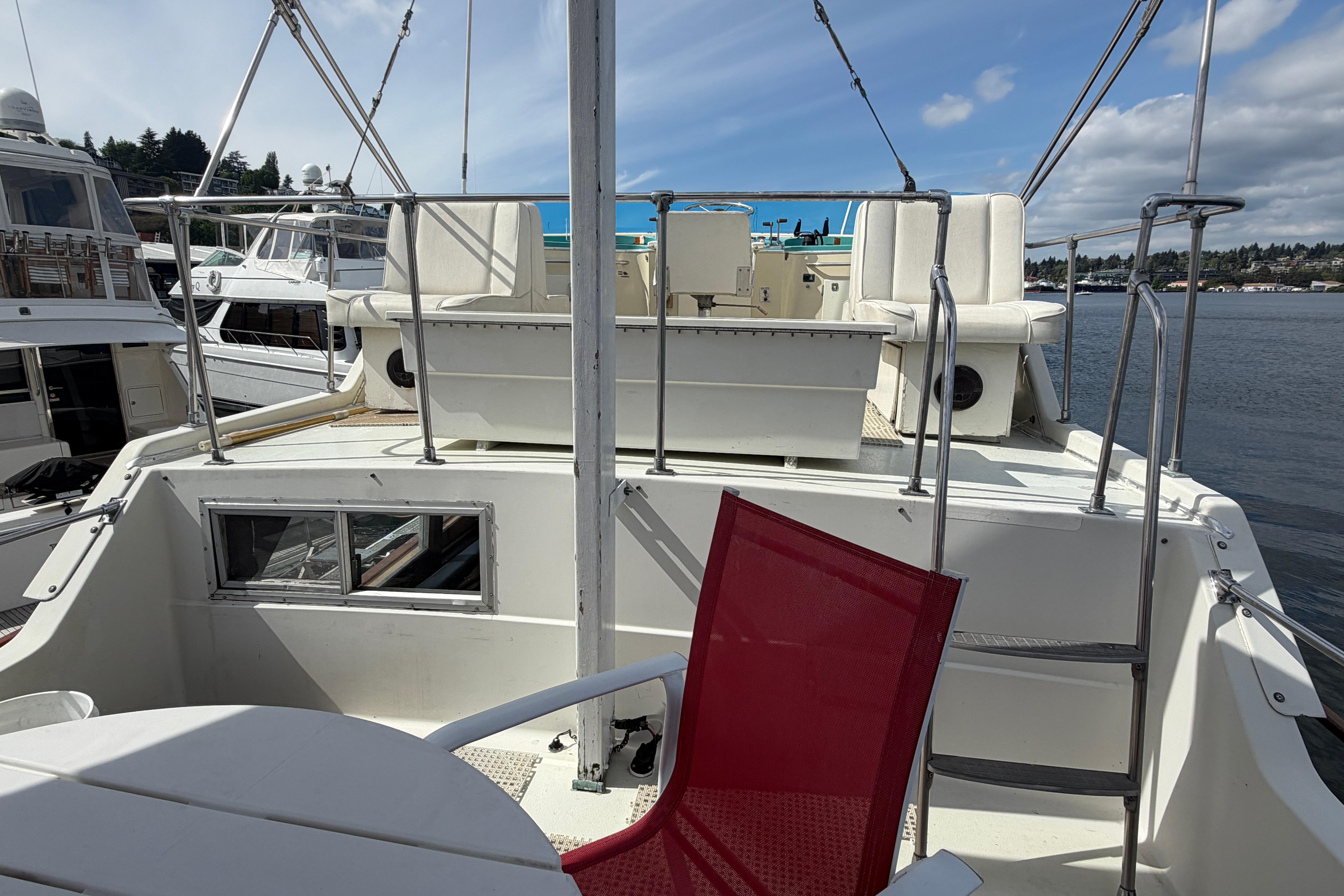 1972 Tollycraft 40 Tri-Cabin Motor Yacht deck with seating and marina view.