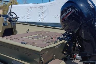 2026 Tracker Grizzly 2072 CC boat with Mercury outboard motor, docked outdoors.