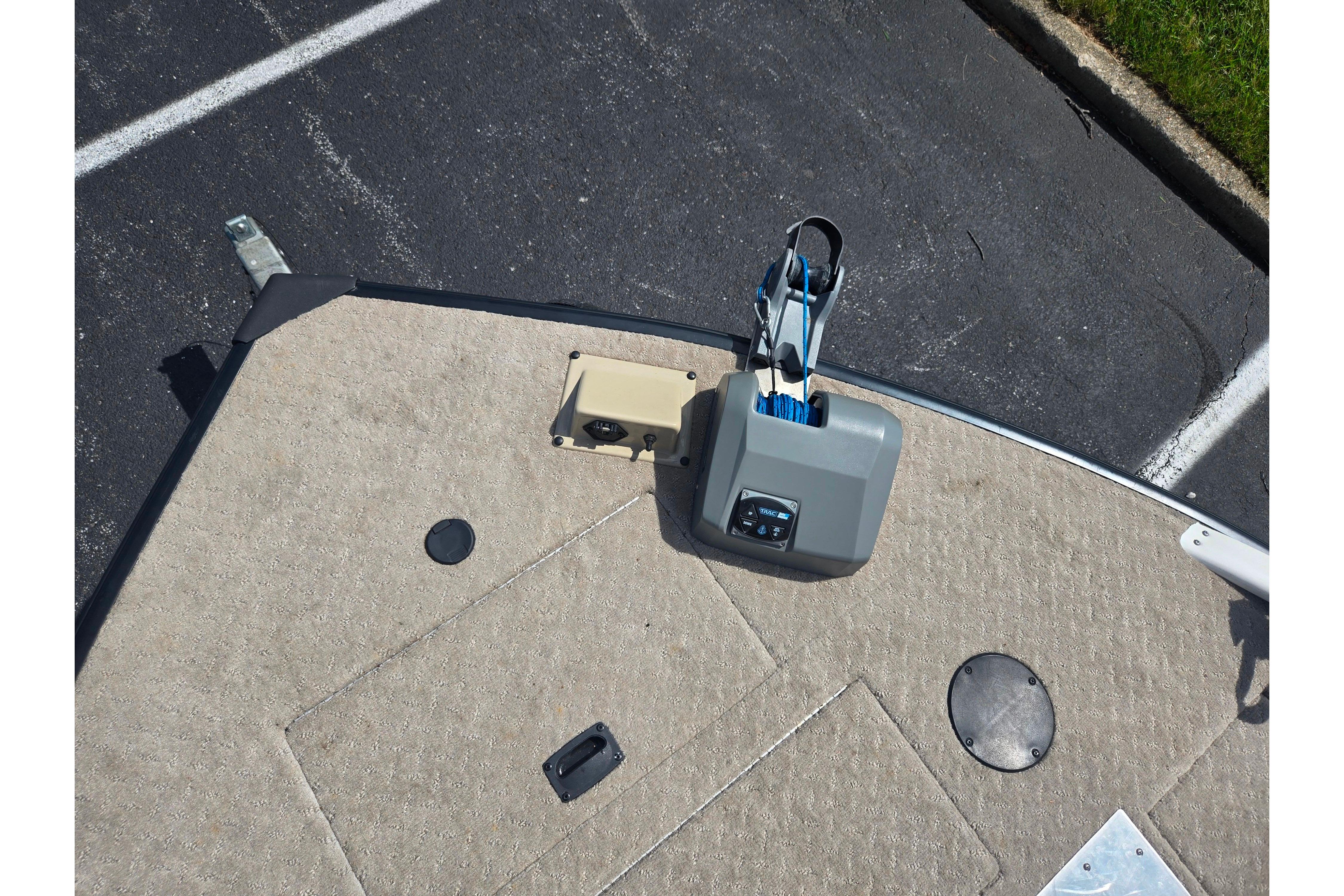 2015 Lowe Sport Deck 224 boat deck with winch and carpeted surface.