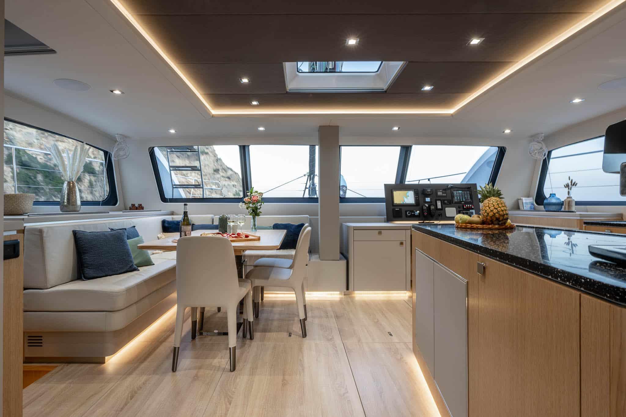 Luxurious interior of 2025 Privilege Signature 580 yacht with modern dining and kitchen area.