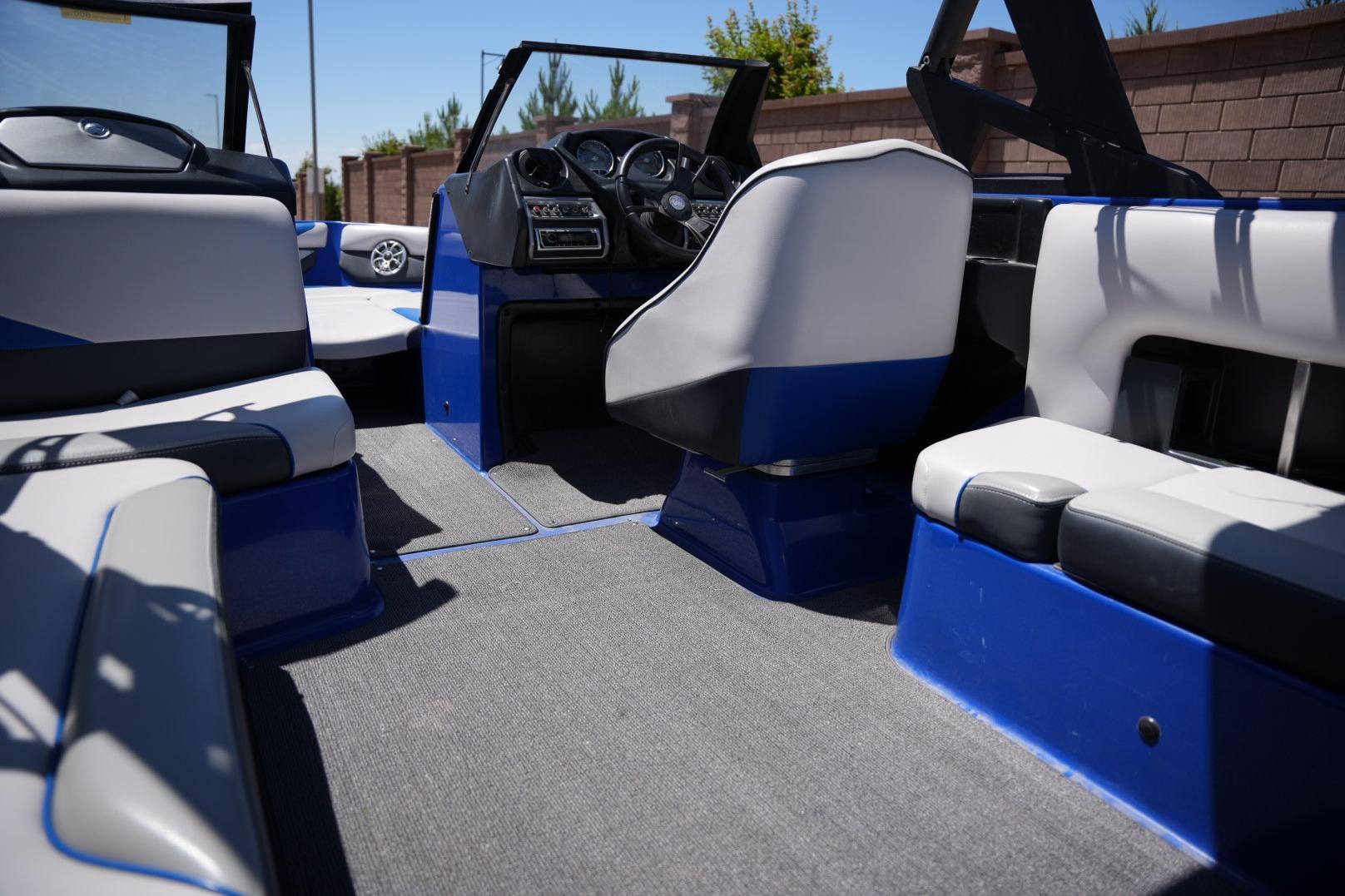 Interior of a 2015 Axis A24 boat with blue and gray seating.