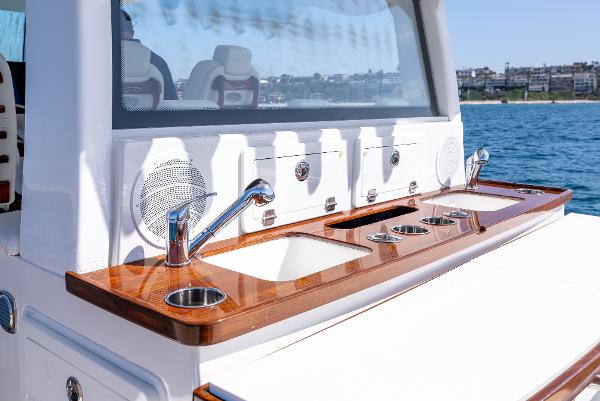 Luxury yacht HCB 53 Sueños 2020 with sleek outdoor kitchen and ocean view.