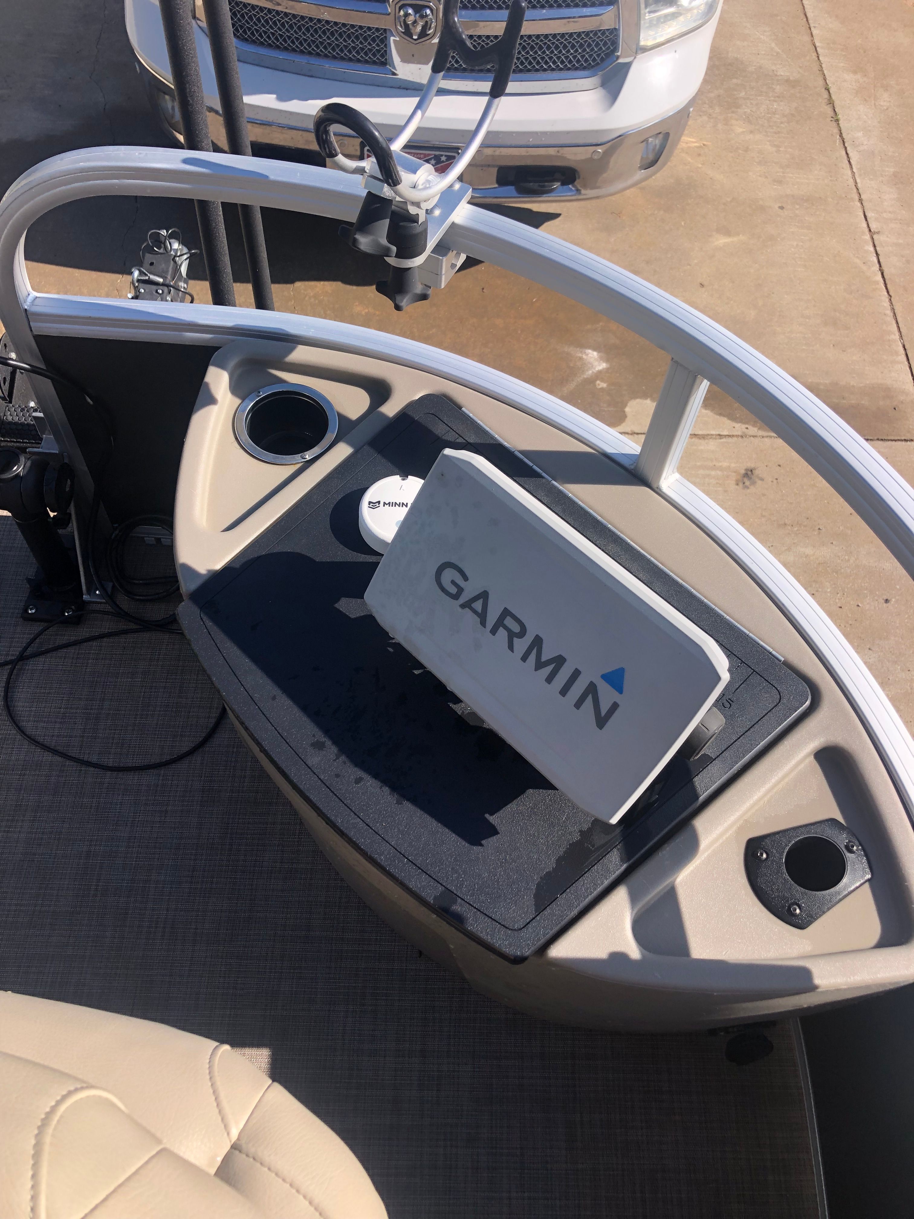 The image shows the helm of a Sun Tracker Fishin' Barge 22 DLX with a Garmin device.